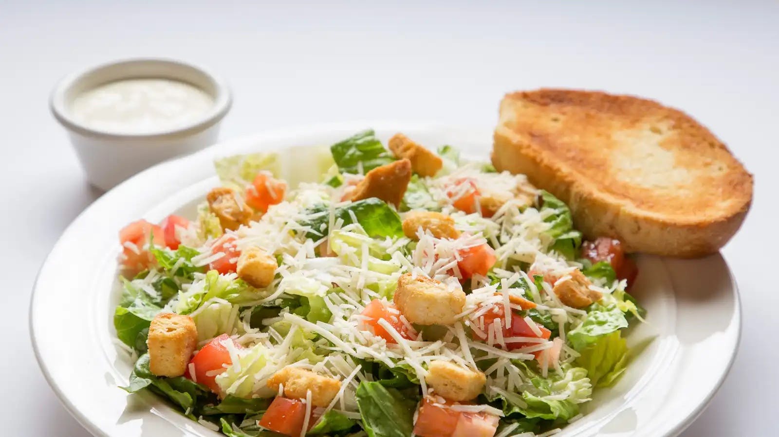 Order Caesar Salad - Salad food online from Carbone's Pizzeria store, Hastings on bringmethat.com