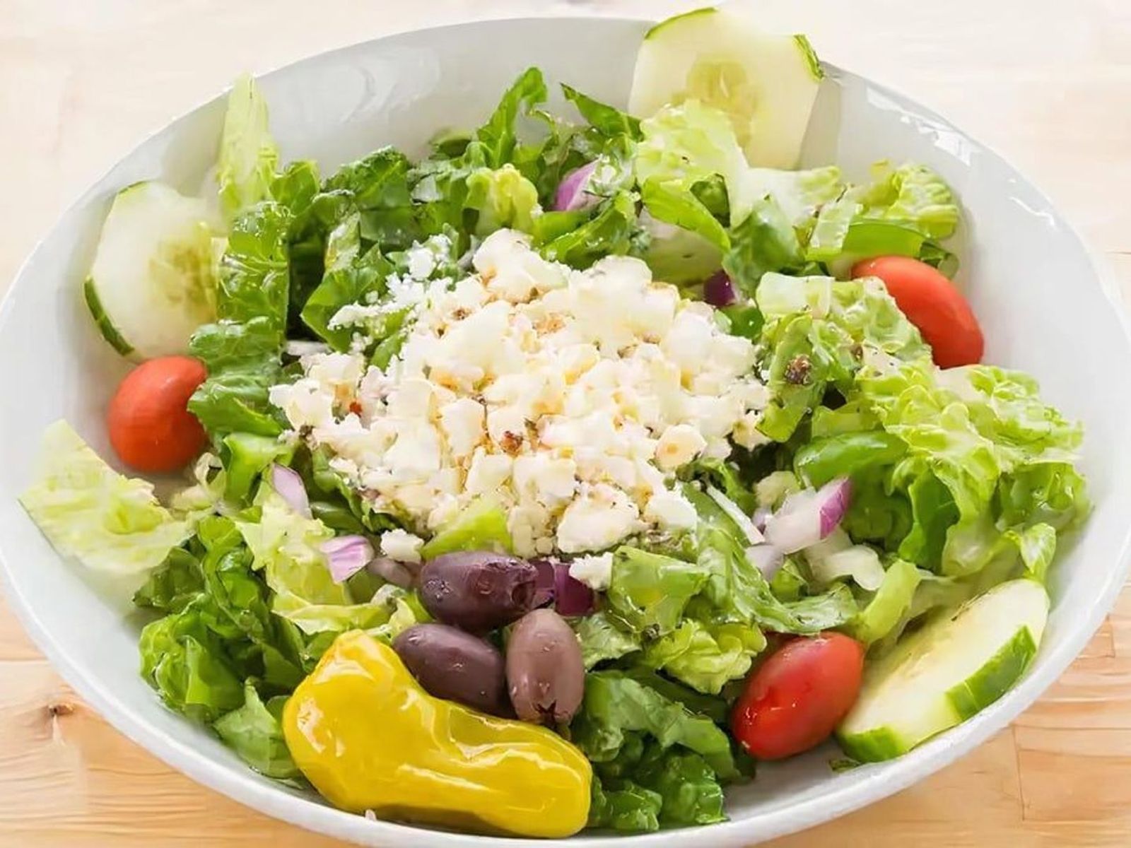 Order Greek Salad food online from Pepperoni's Pizza store, Sugar Land on bringmethat.com