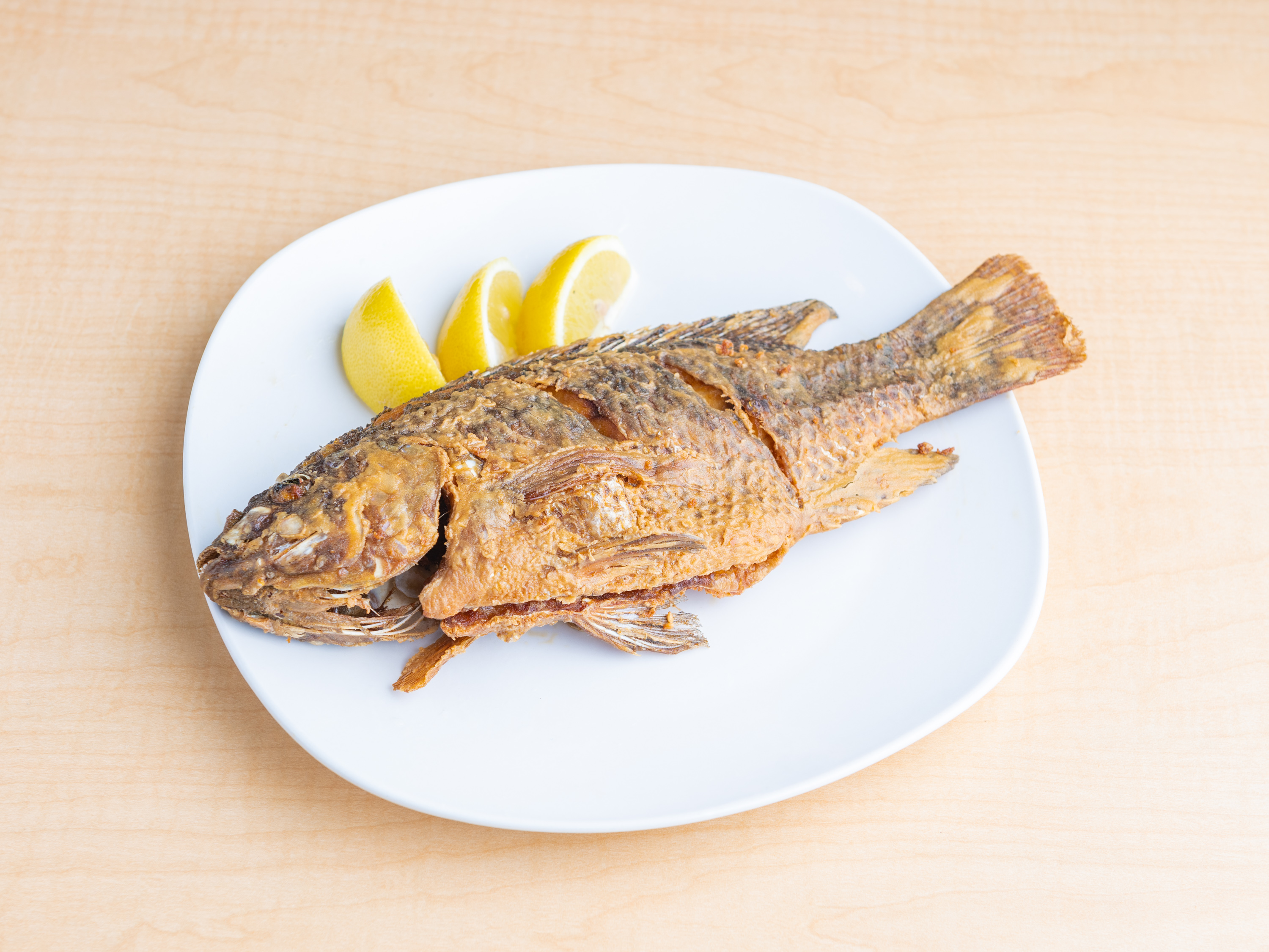 Order S7. Fried Tilapia food online from Macky Kitchen store, Richmond on bringmethat.com