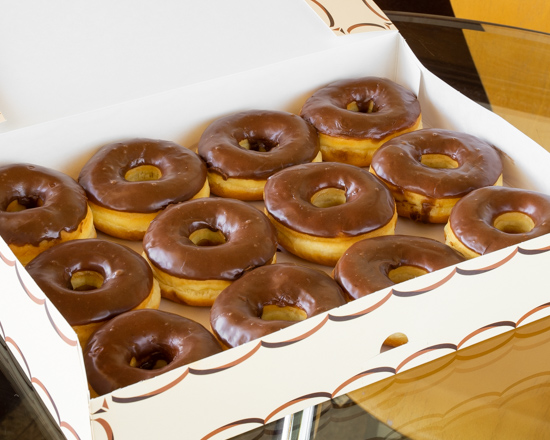 Order Chocolate Iced Glazed Doughnuts food online from Momma's Donuts store, White Settlement on bringmethat.com