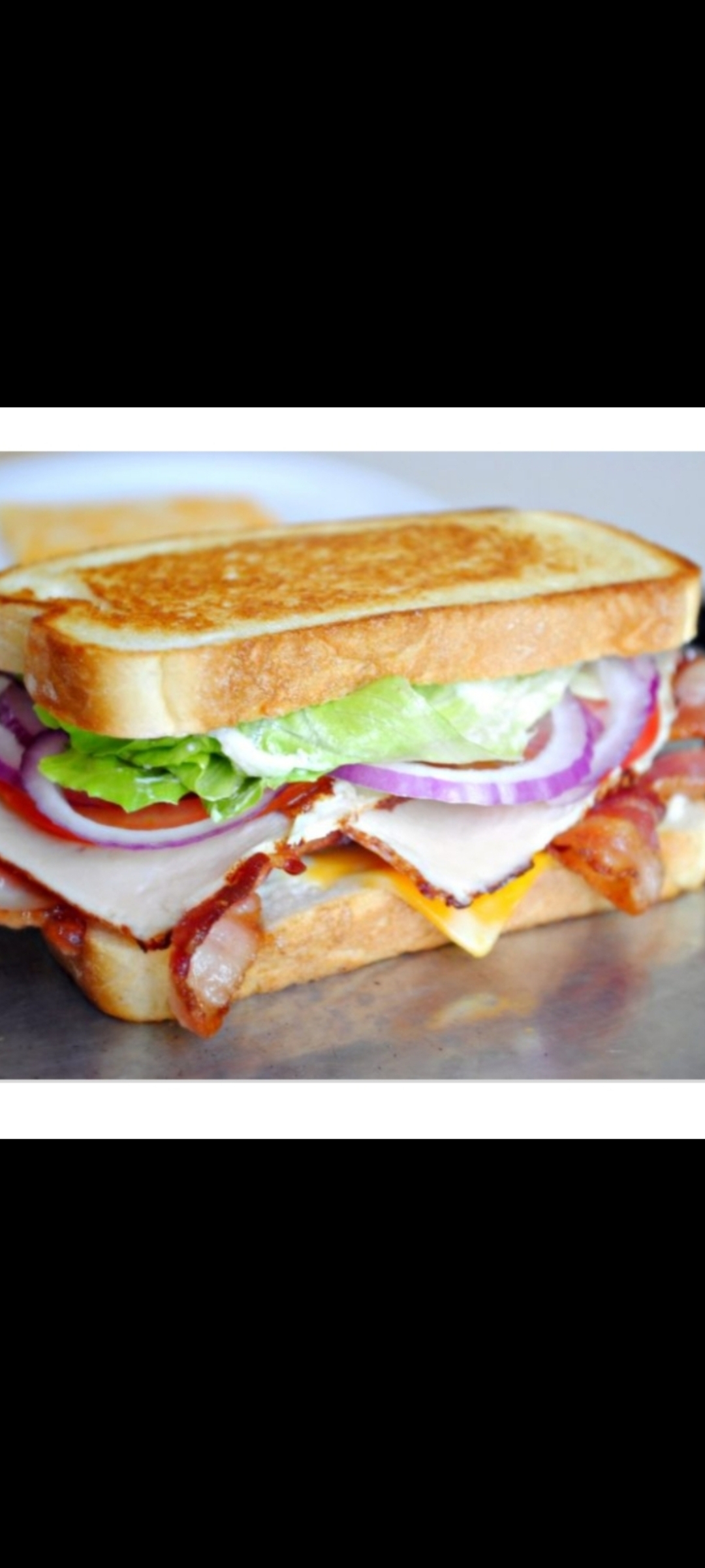 Order The Club Sandwich (turkey & bacon cheese lettuce tomatoes red onions) food online from American Gourmet Foods Deli store, New York on bringmethat.com