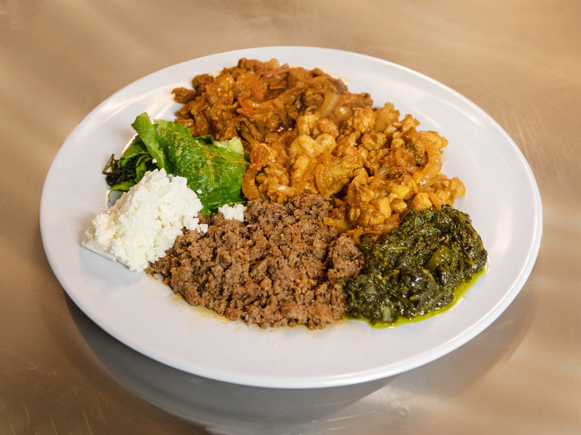 Order Kitfo food online from Axum Cafe store, San Francisco on bringmethat.com