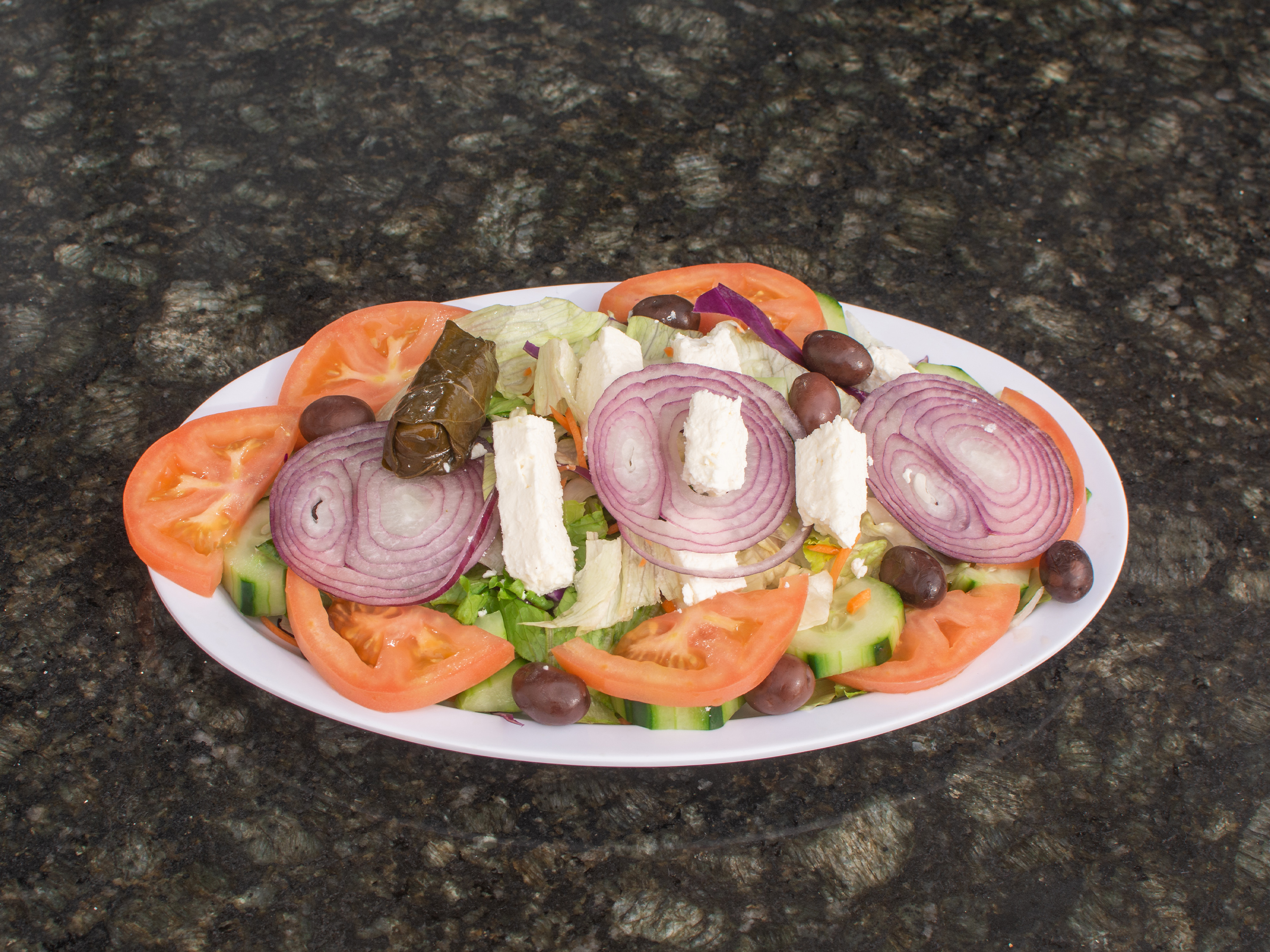 Order Greek Salad food online from New York Pizza & Grill store, Dinuba on bringmethat.com