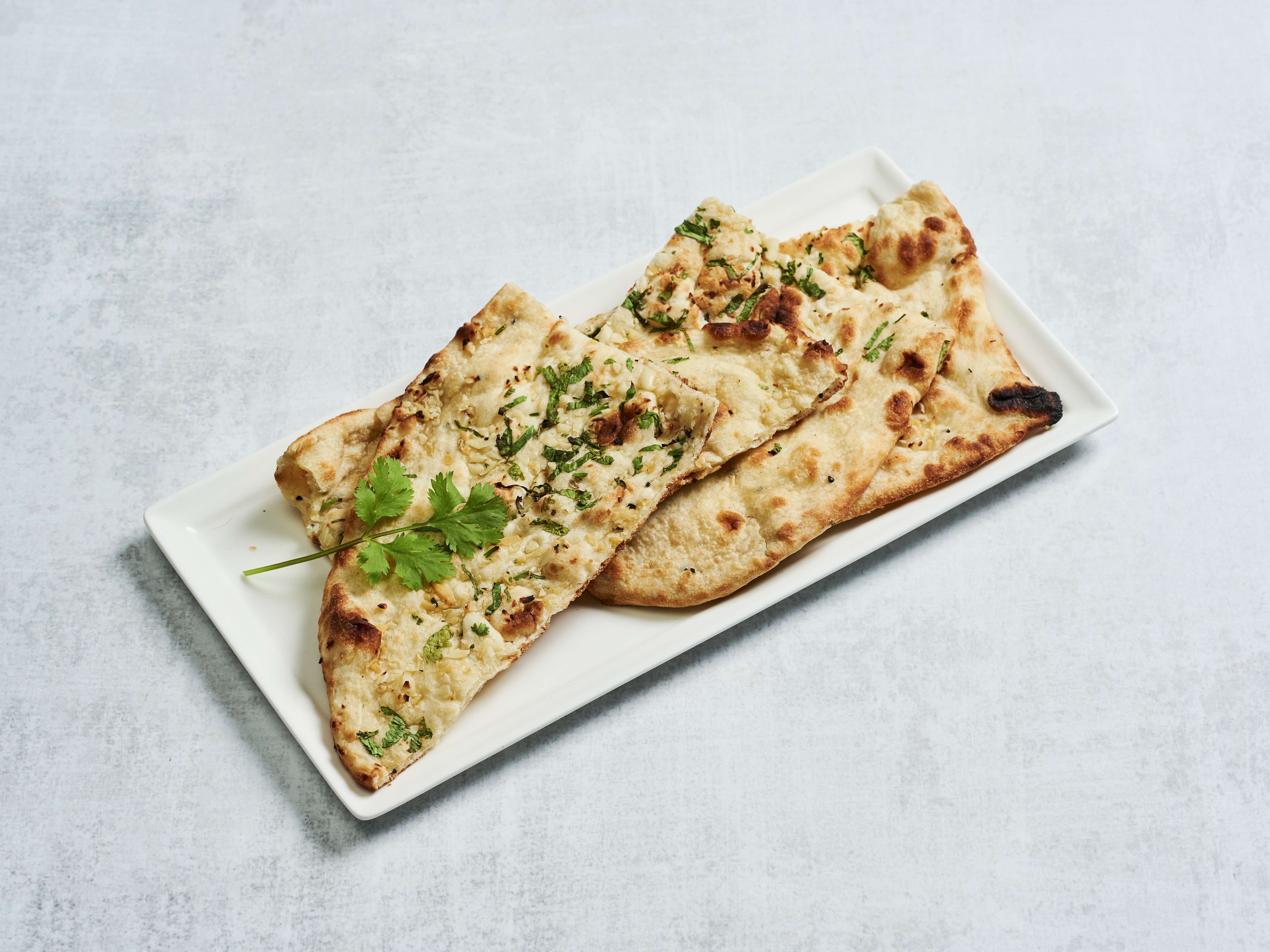 Order Garlic Naan food online from Mahan Indian Restaurant store, Alhambra on bringmethat.com