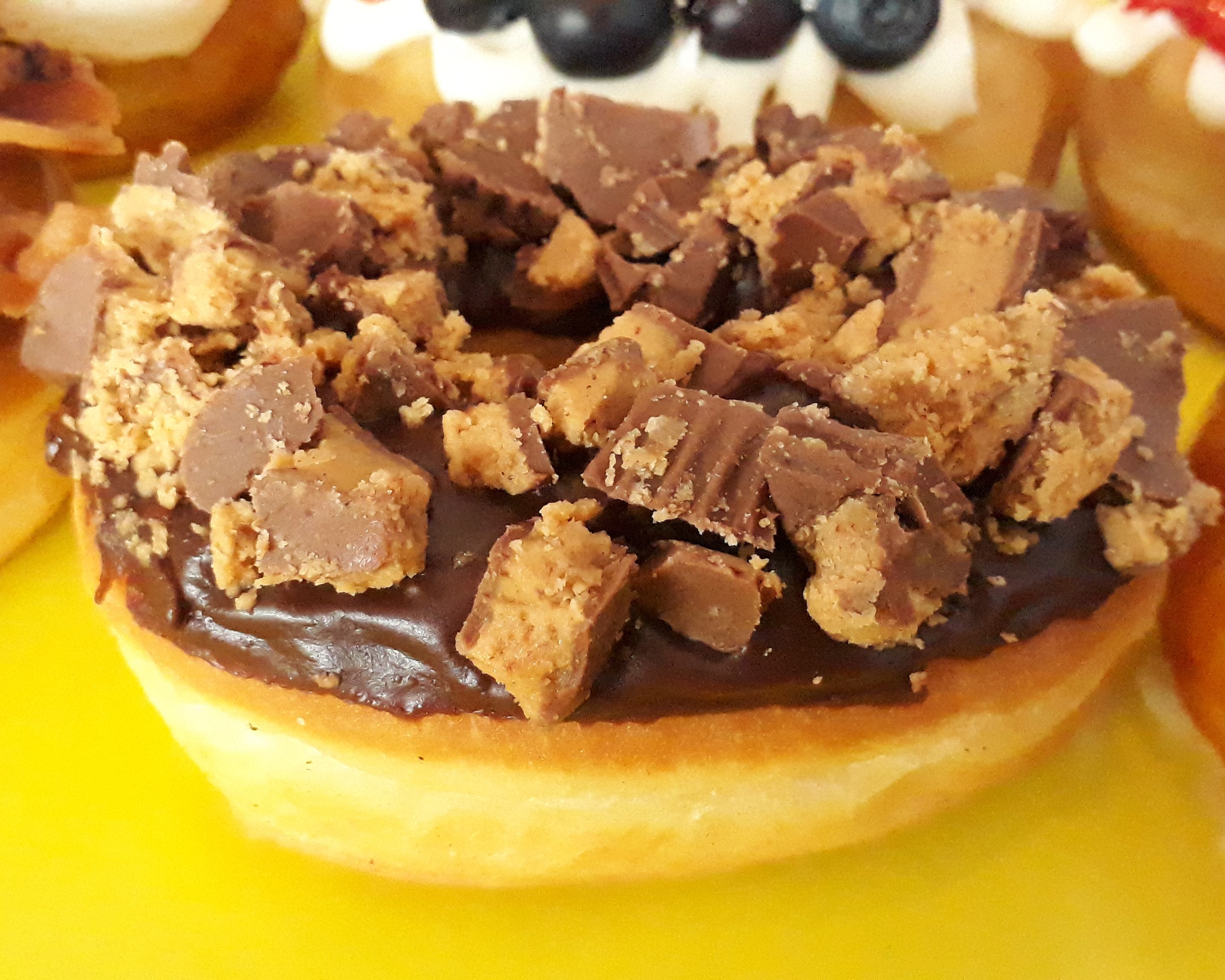 Order Reeses Topped Donut food online from Jaram's Donuts store, Dallas on bringmethat.com