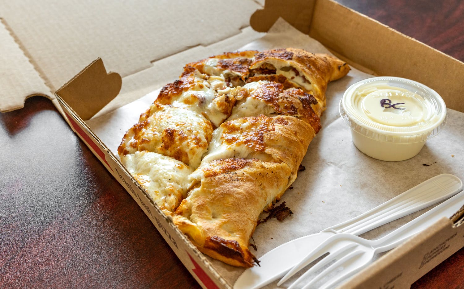 Order Buffalo Chicken Calzone food online from Broadway Pizza and Grill store, Norwood on bringmethat.com