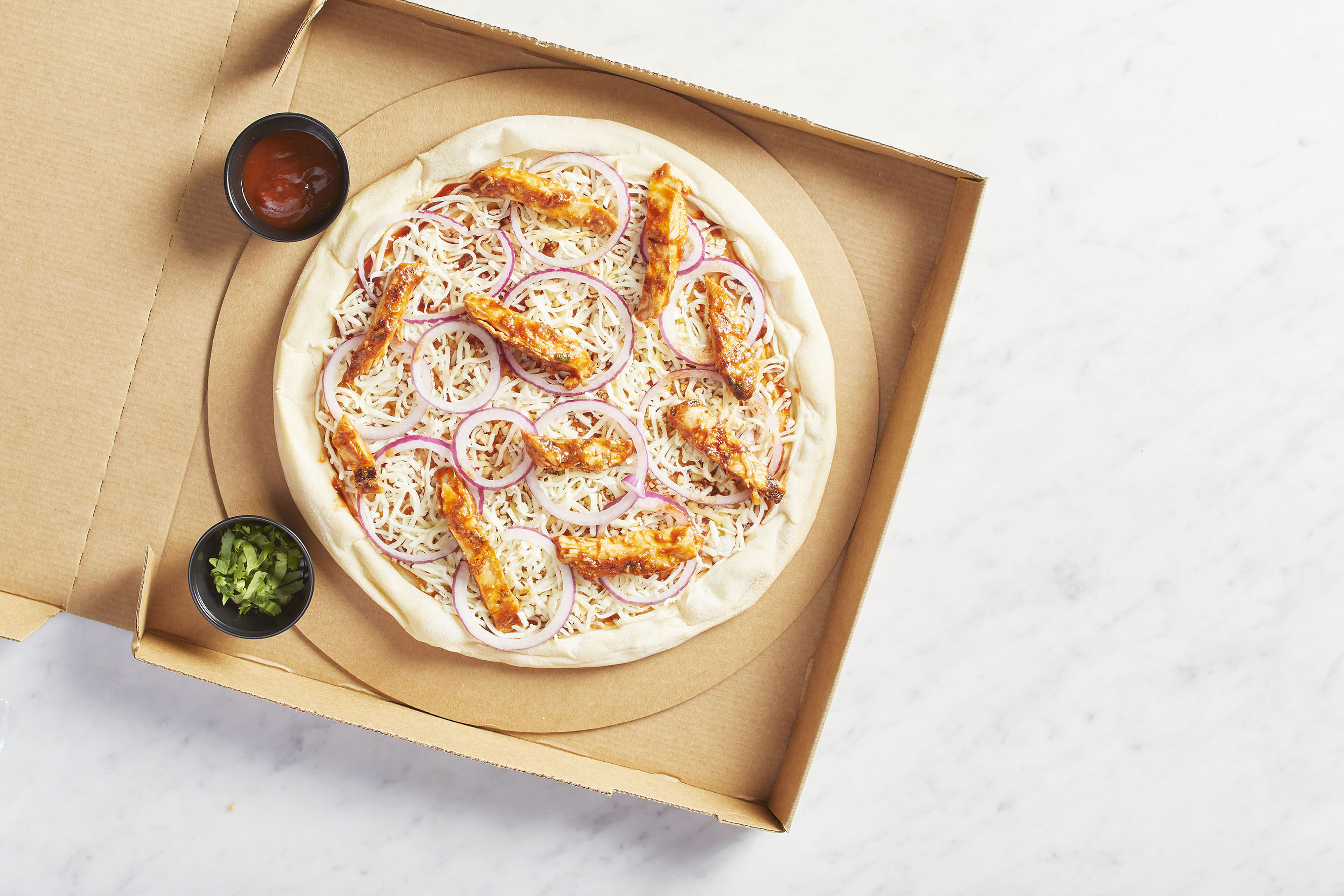 Order Take and Bake The Original BBQ Chicken Pizza food online from California Pizza Kitchen - River City Dr store, Jacksonville on bringmethat.com