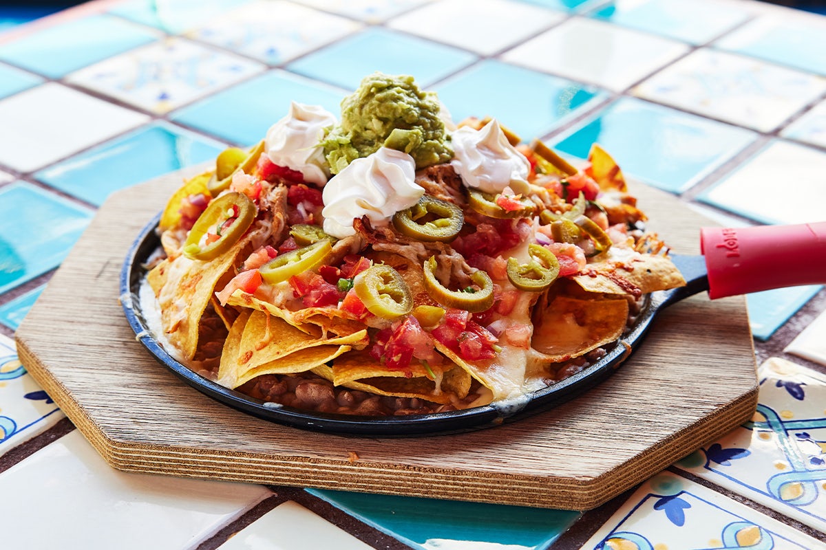 Order Loaded Skillet Nachos food online from Margarita's Mexican Restaurant store, Exeter on bringmethat.com
