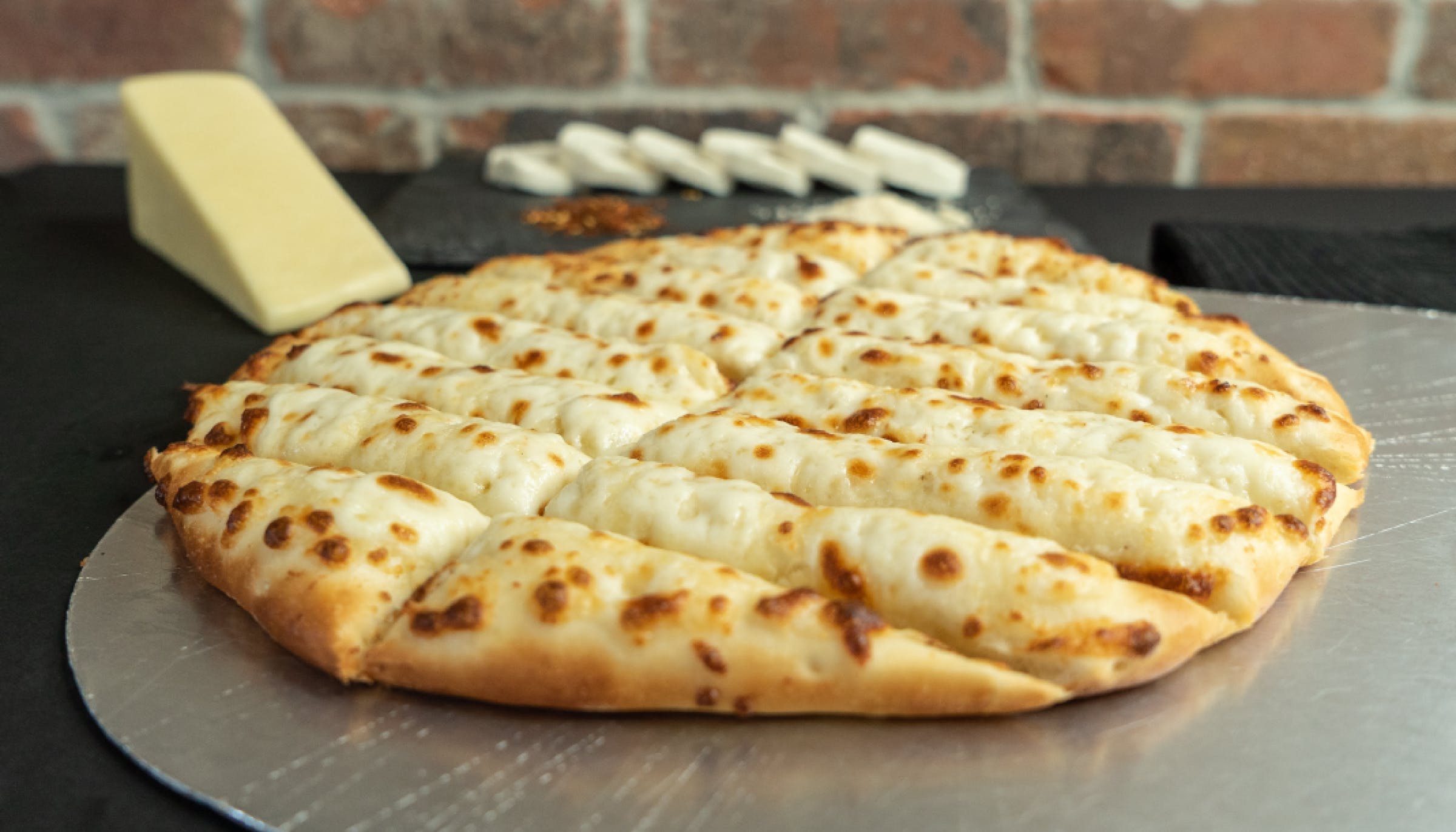 Order Cheesebread - Breadsticks food online from Tenney's Pizza store, Saratoga Springs on bringmethat.com