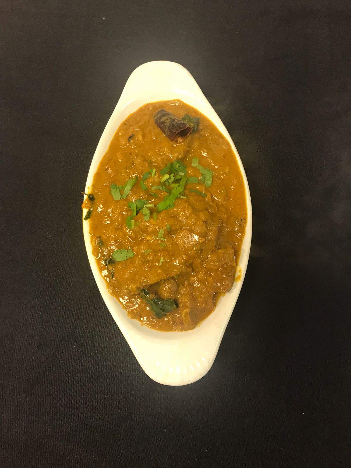 Order Goat Curry food online from Paradise Biryani Pointe store, Parma on bringmethat.com
