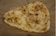 Order Garlic Naan food online from Tikka Taj store, McAllen on bringmethat.com