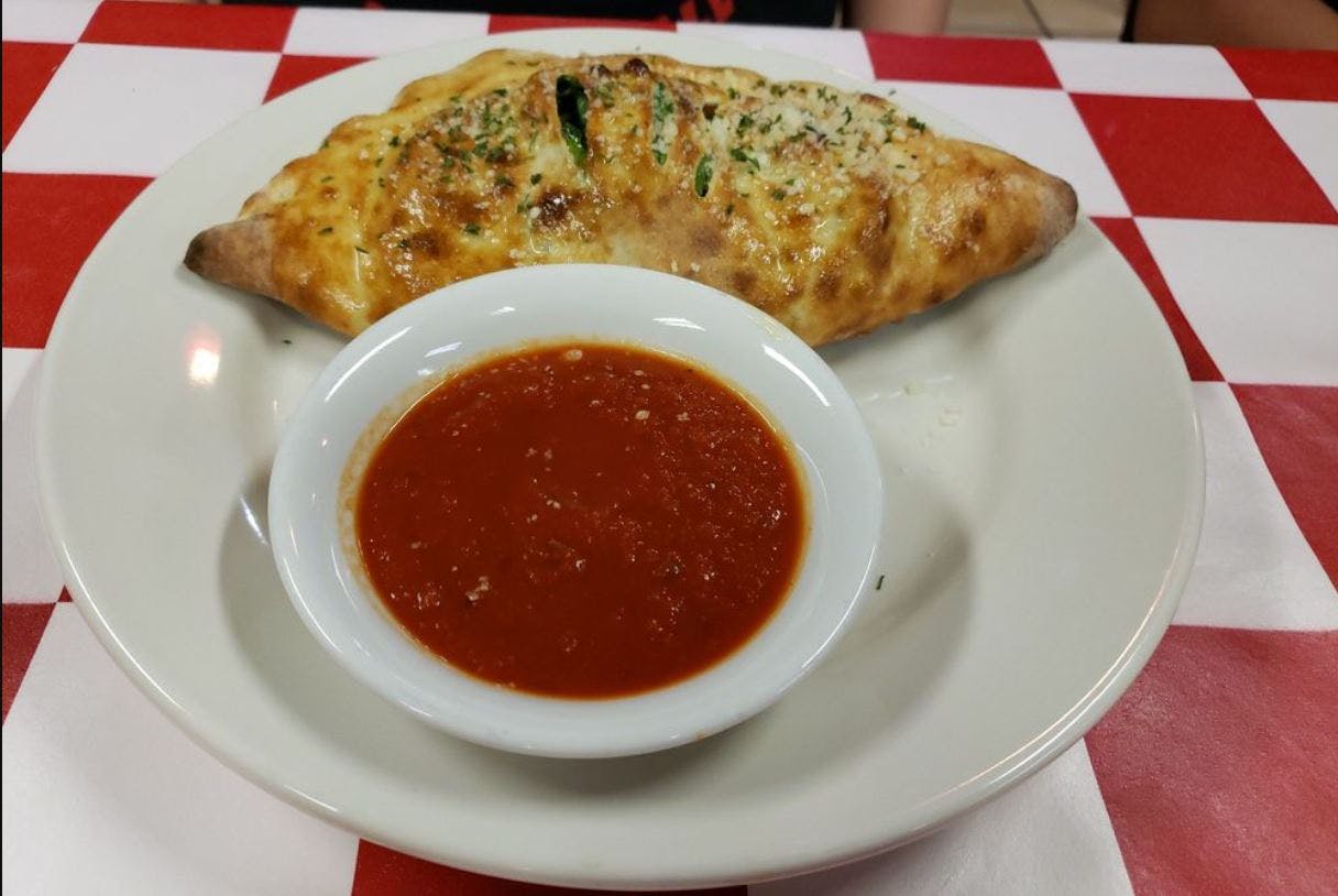 Order Spinach Calzone - Calzone food online from Goomba Pizza store, San Antonio on bringmethat.com