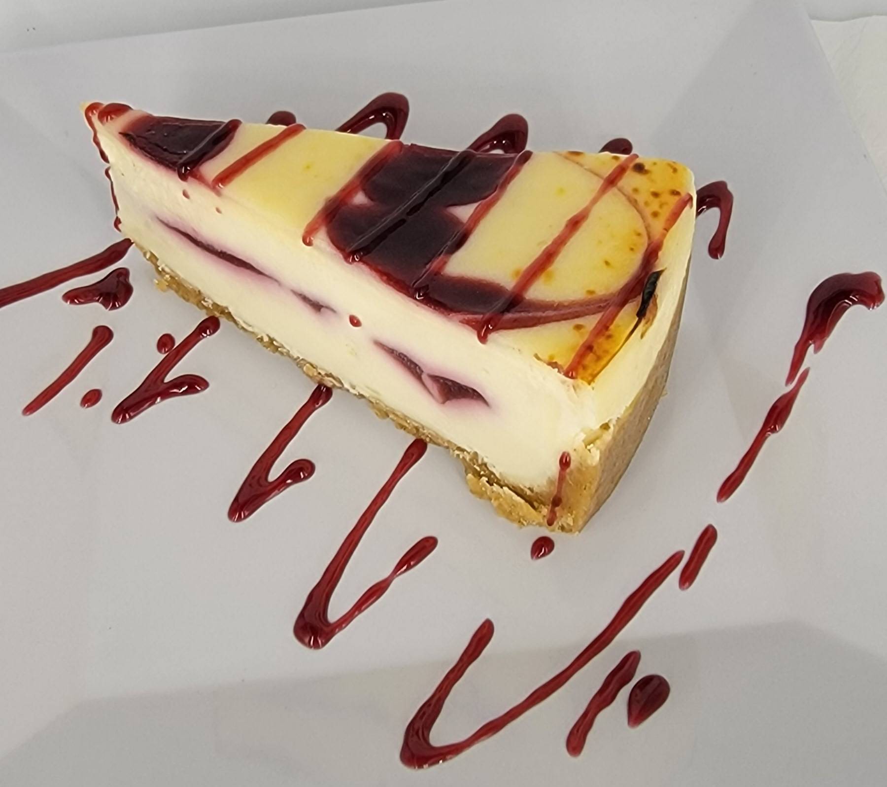 Order RASPBERRY WHITE CHOCOLATE CHEESECAKE food online from Christine Casual Dining store, Green on bringmethat.com