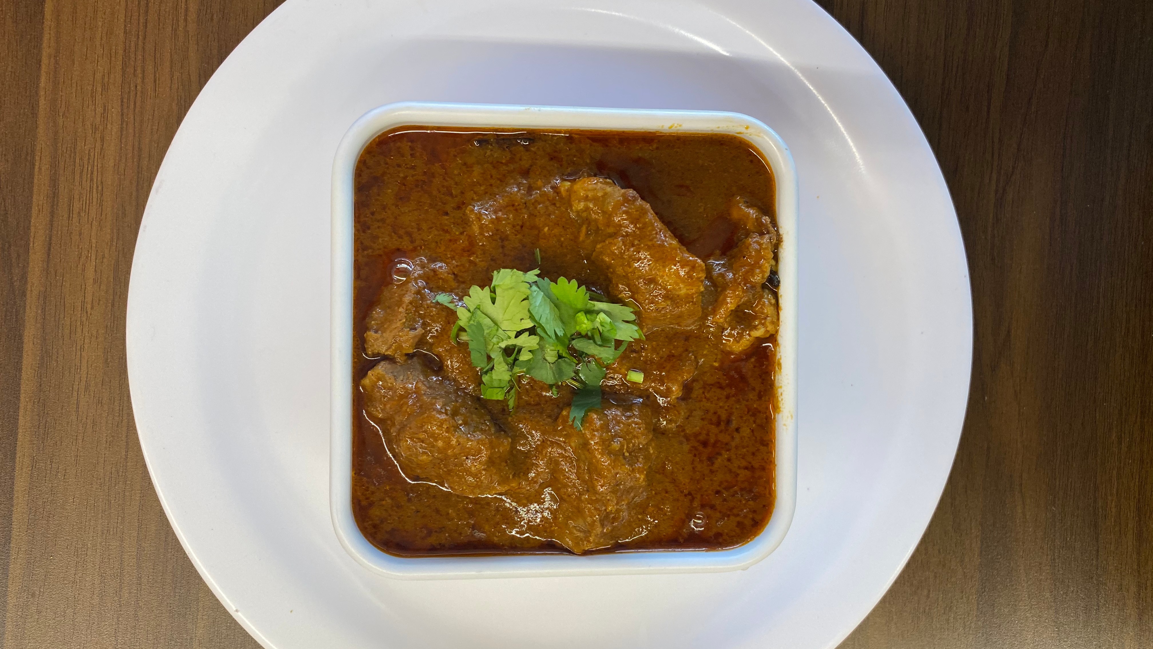 Order Lamb Curry food online from Indian Cafe store, East Moline on bringmethat.com