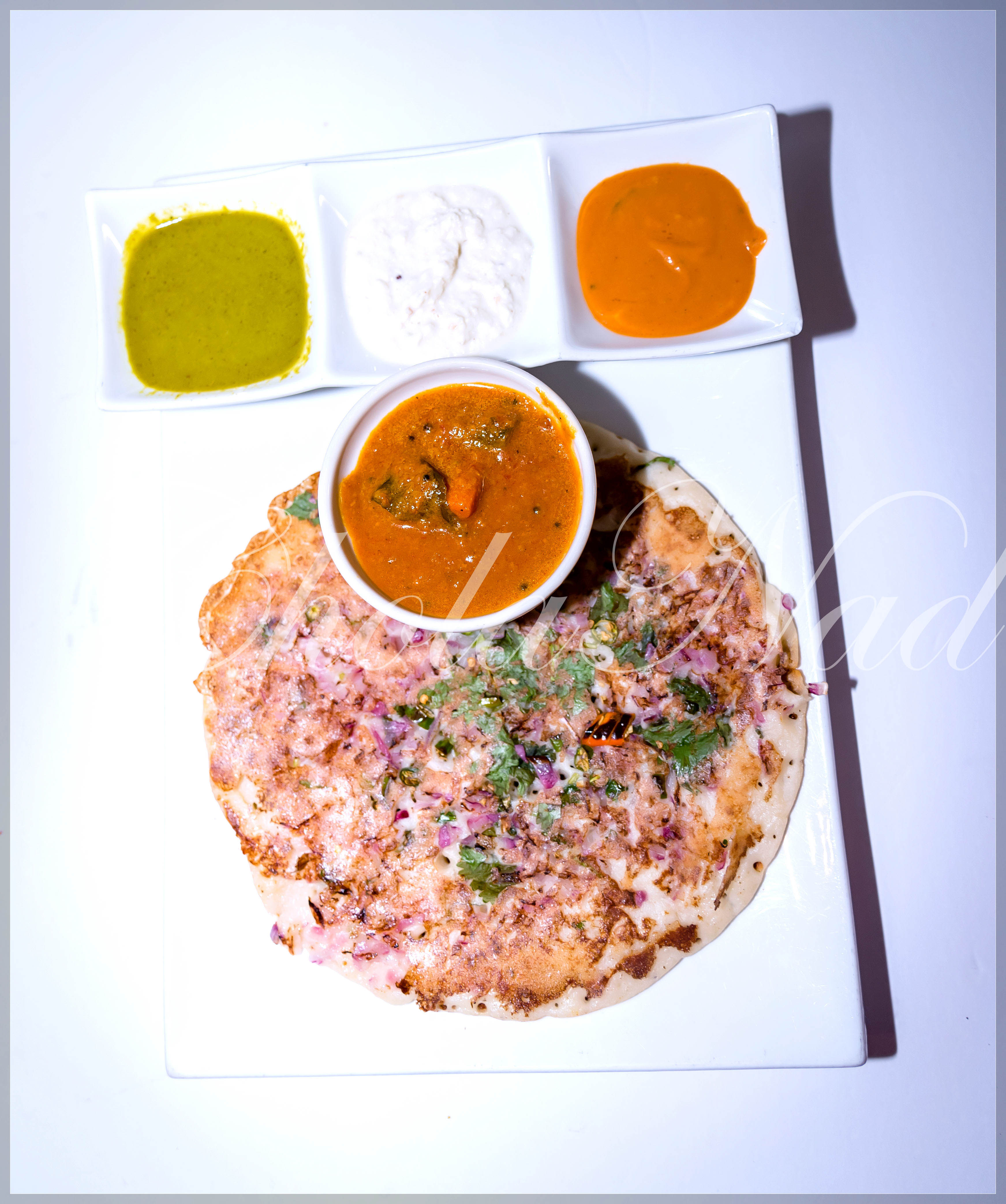 Order Veggie Uthappam food online from Cholanad store, Chapel Hill on bringmethat.com