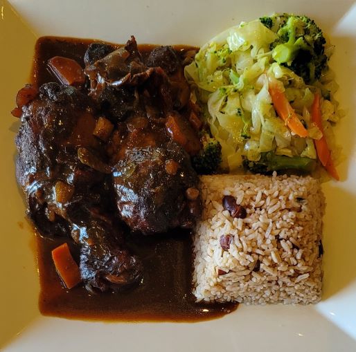Order Brown Stew Chicken food online from Paradise Place Jamaican Cuisine store, Las Vegas on bringmethat.com