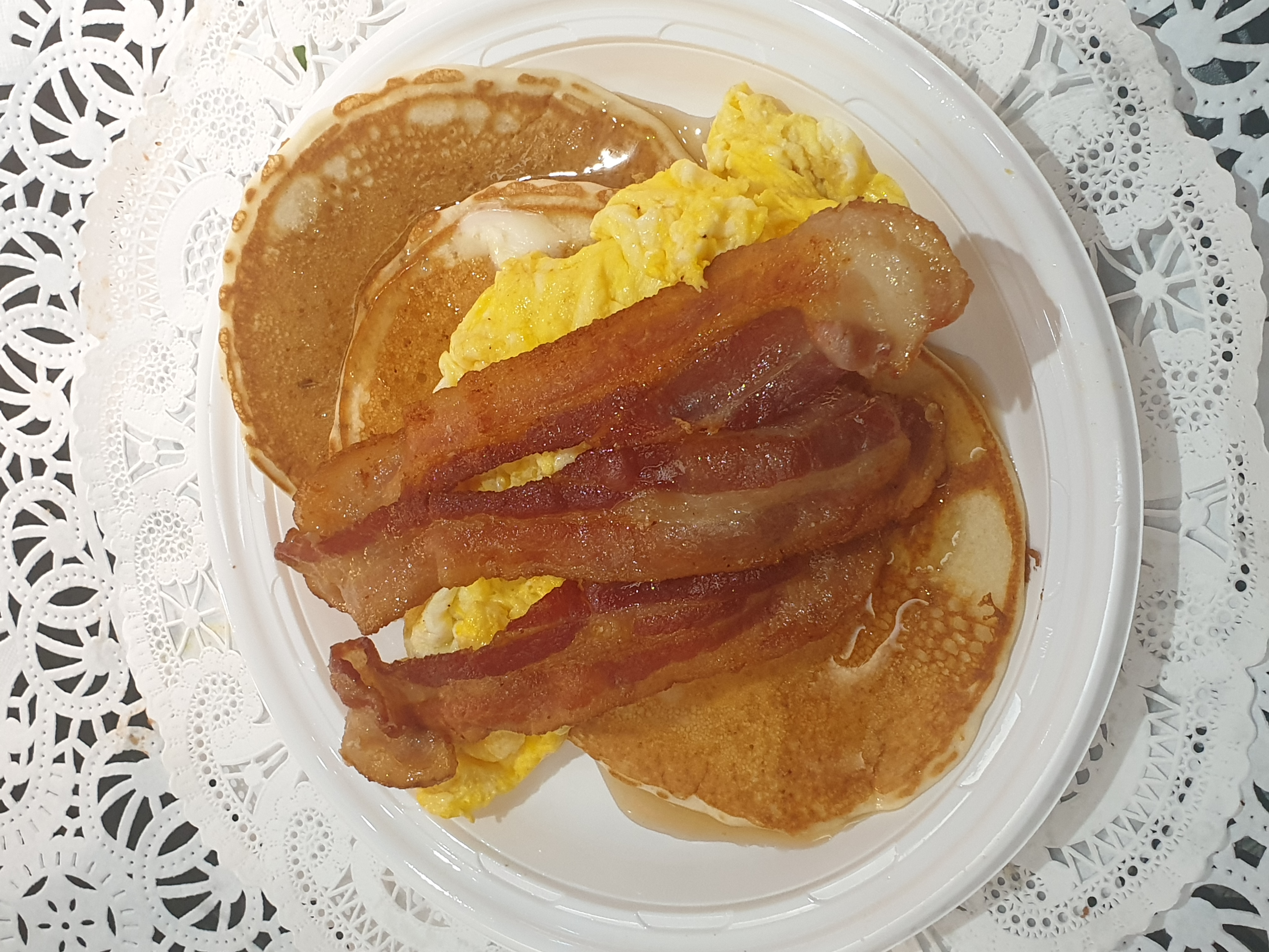 Order 12B-3 Piece Buttermilk Pancakes with Scrambled Eggs & Bacon food online from Taz Cafe store, New York on bringmethat.com
