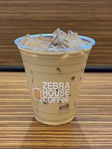 Order Iced Cortado food online from Zebra House Coffee store, San Clemente on bringmethat.com