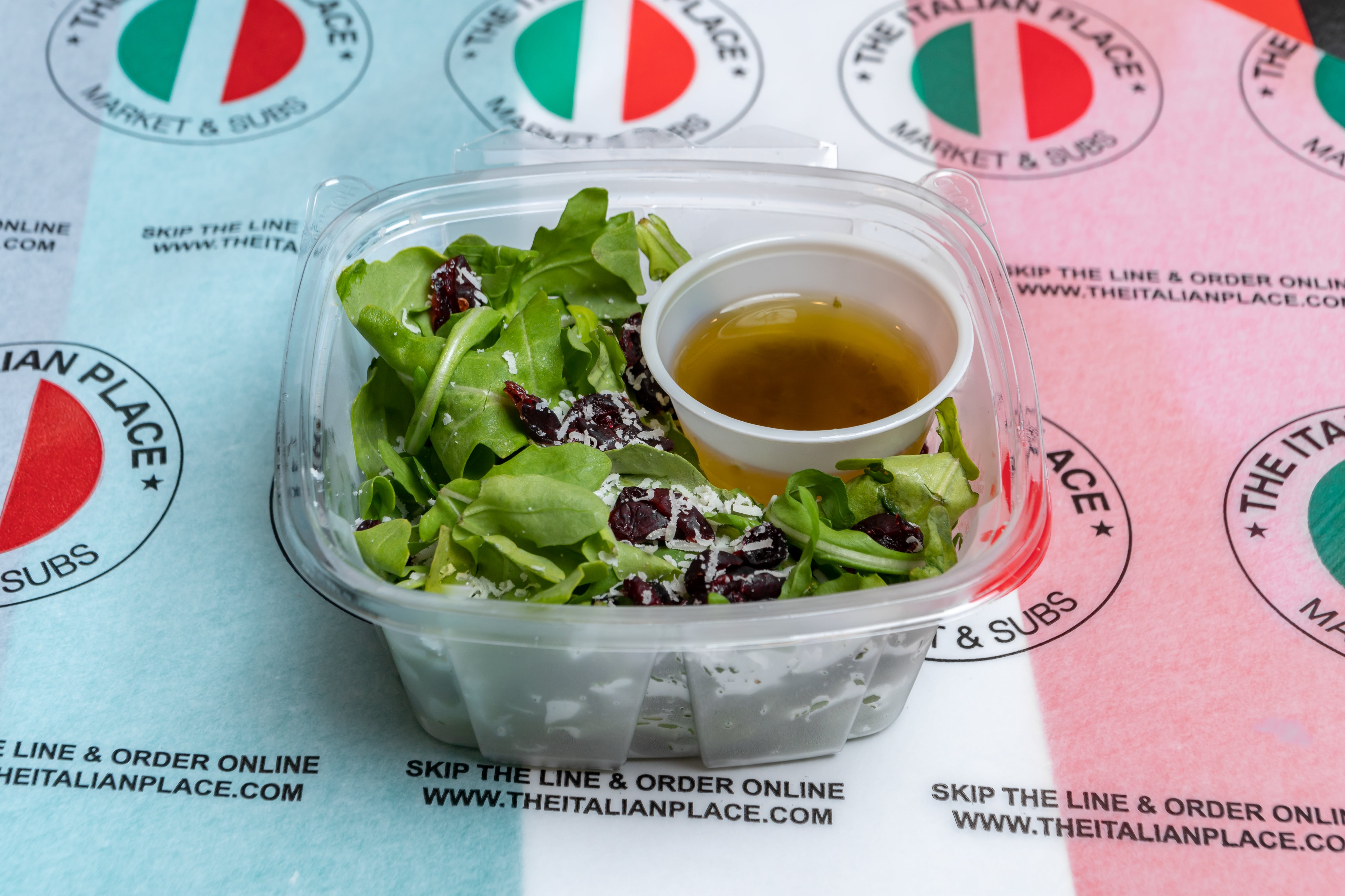 Order Arugula & Cranberry Salad - Half food online from The Italian Place store, Fairfax on bringmethat.com