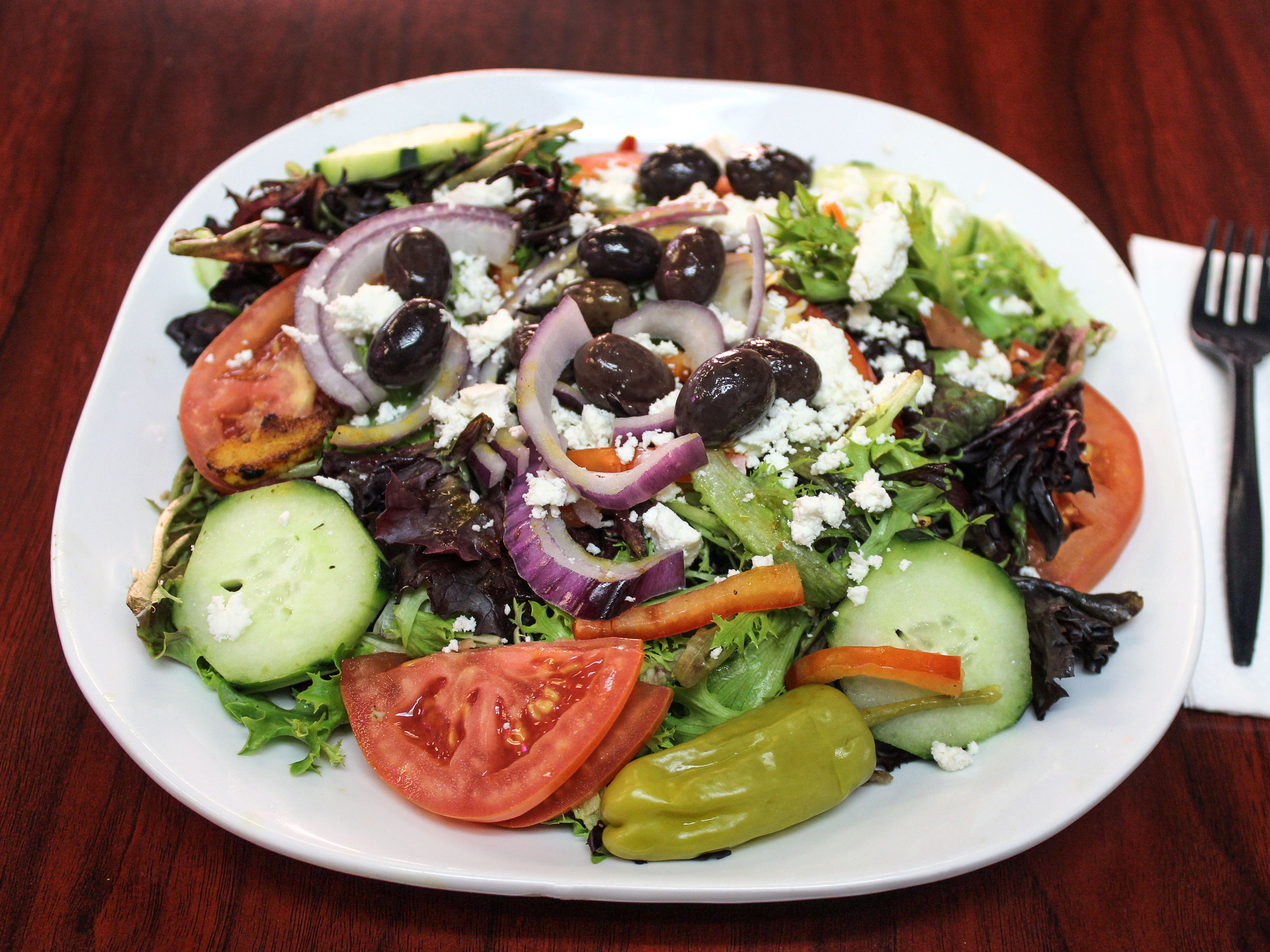 Order Greek Salad food online from Munchies Cafe store, Tempe on bringmethat.com