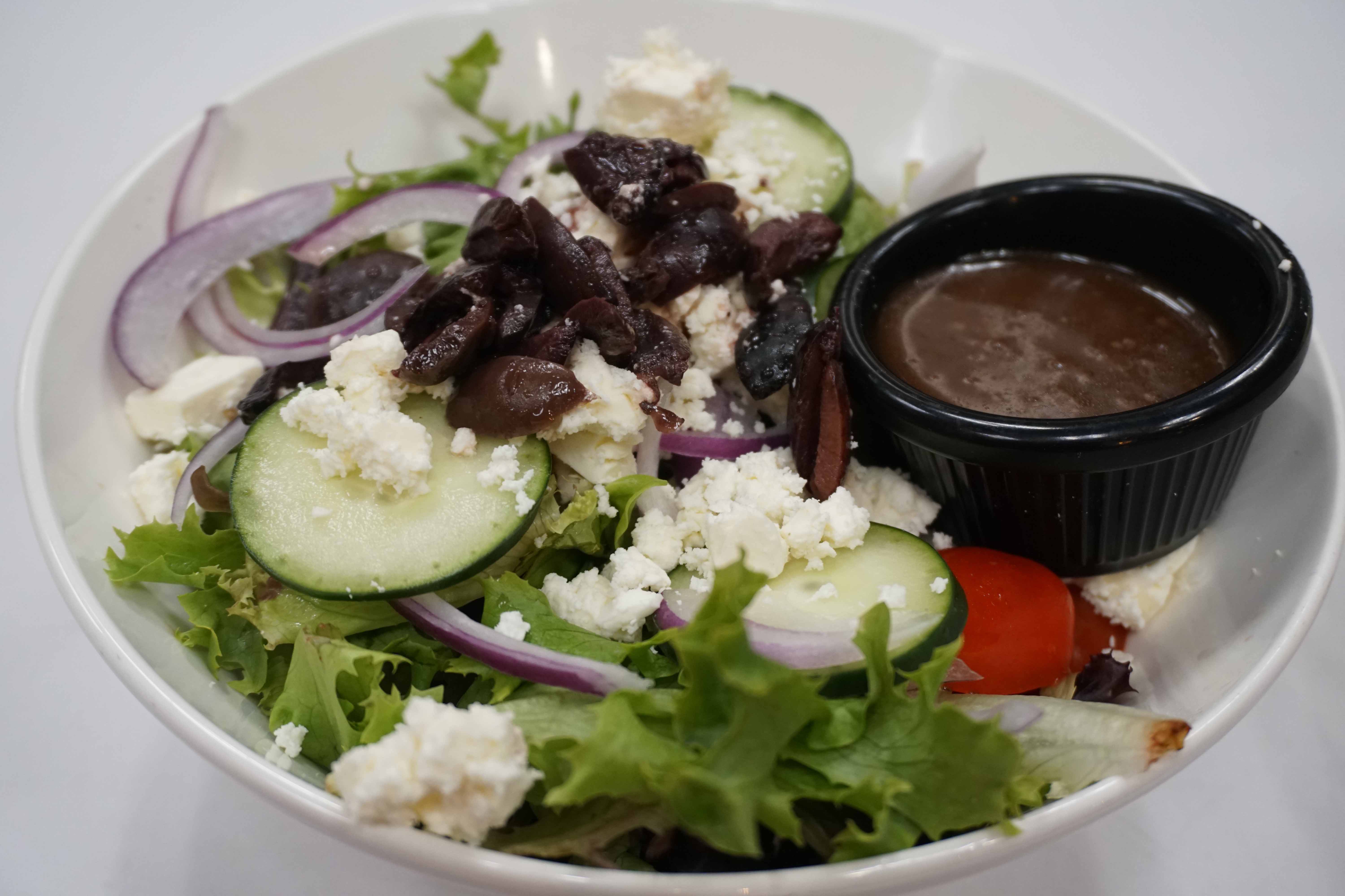 Order Greek Salad food online from zpizza Tap Room store, La Jolla on bringmethat.com