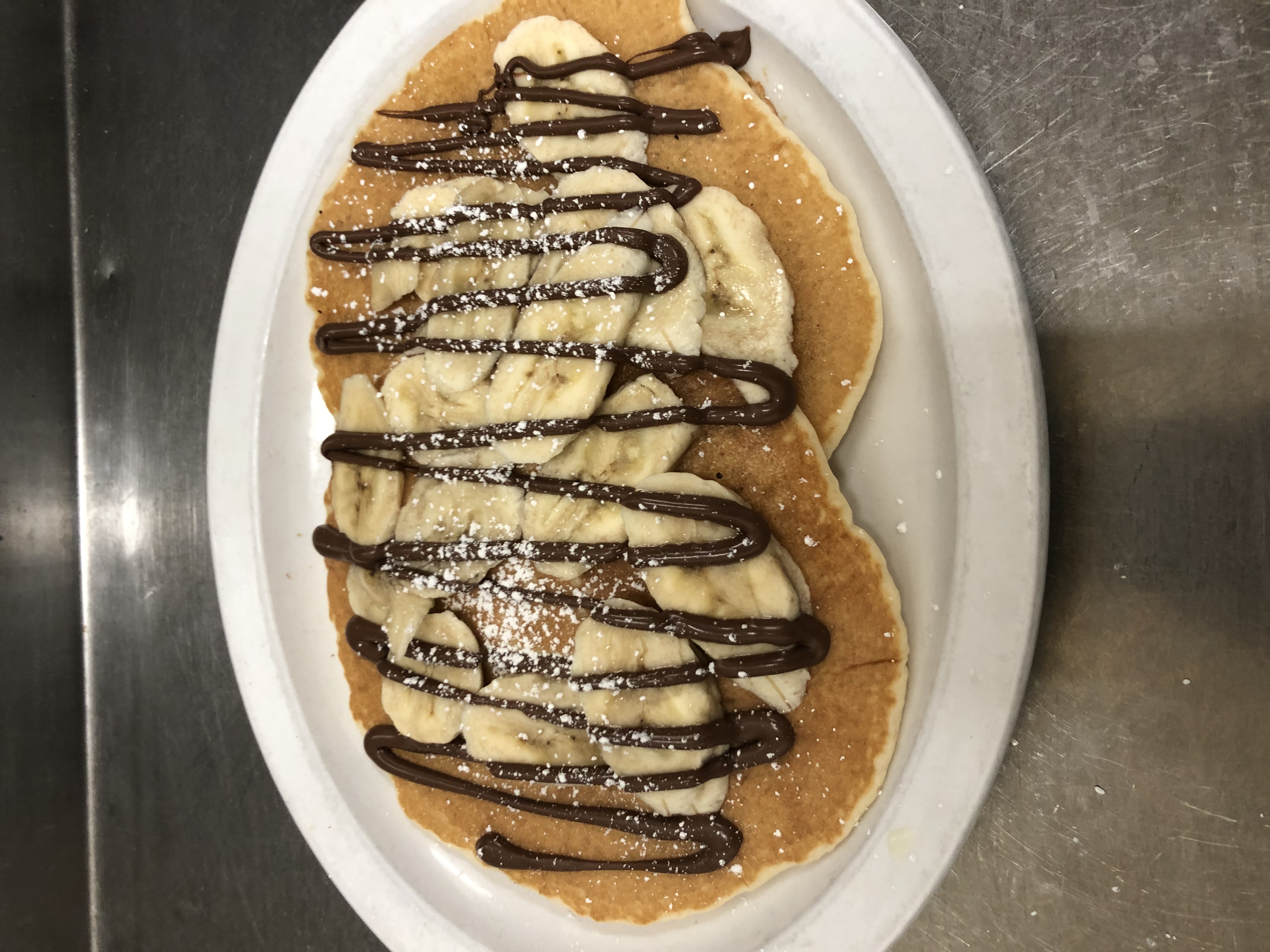 Order Banana Nutella pancakes and 2 eggs food online from Al's Cafe In The Village store, Carlsbad on bringmethat.com