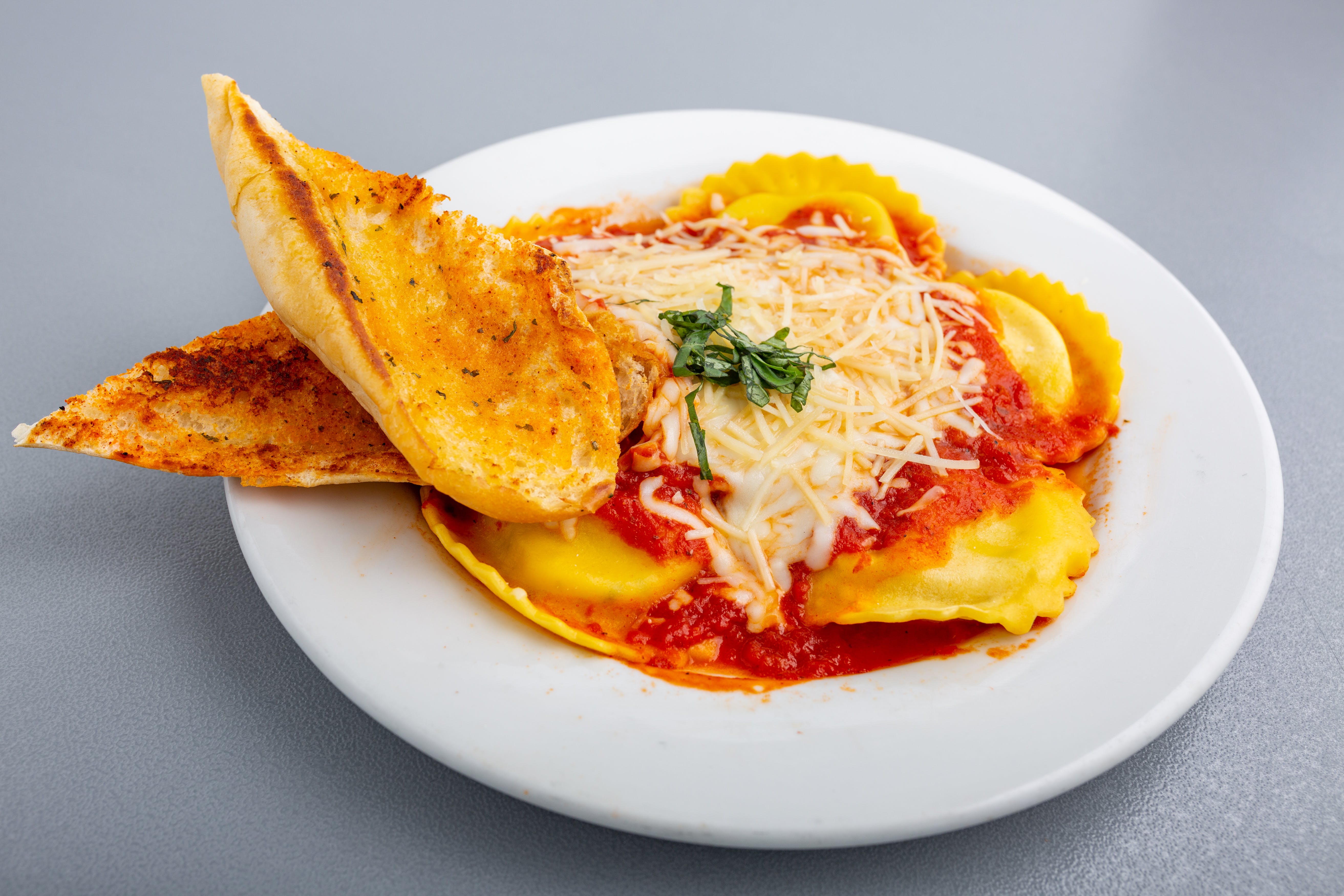 Order Ravioli with Marinara Sauce - Pasta food online from Napoli Pizza store, Henderson on bringmethat.com