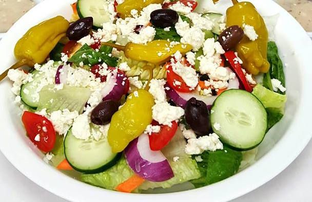 Order Greek Salad food online from Nostra Pizza store, Greensboro on bringmethat.com