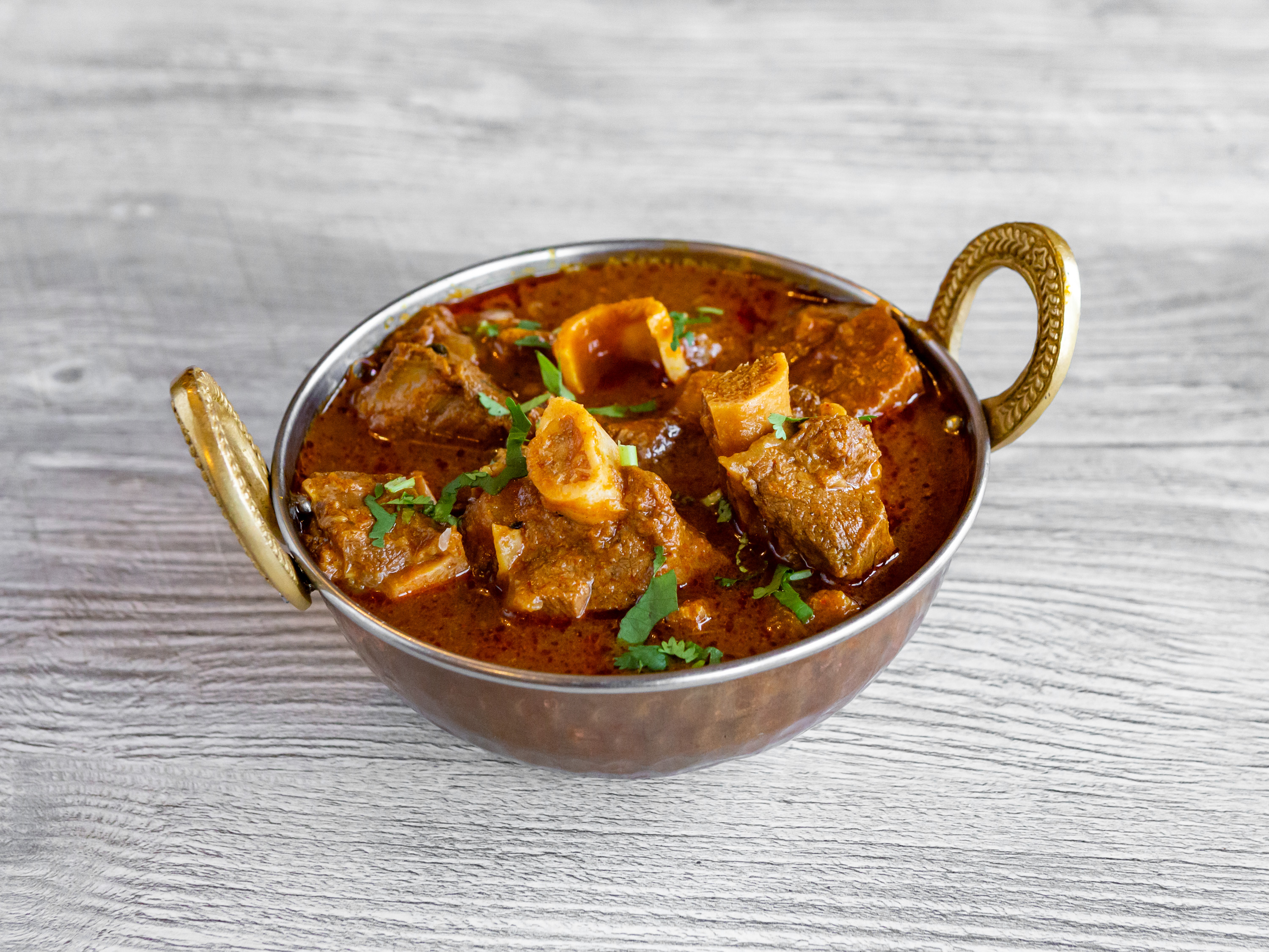 Order Goat Curry food online from Indian Village Restaurant store, Greenfield on bringmethat.com