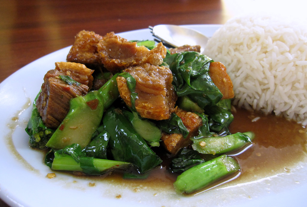 Order 64. Crispy Pork with Chinese Broccoli over Rice food online from Boran thai restaurant store, Los Angeles on bringmethat.com