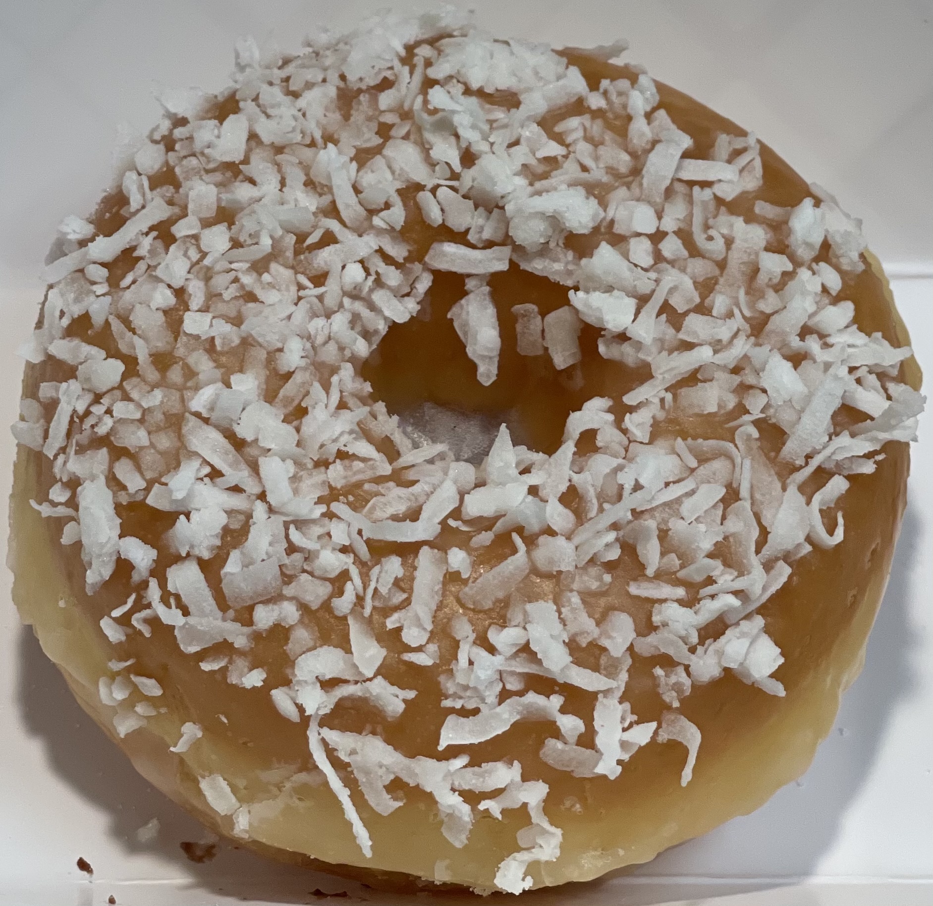 Order Raised Coconut Donut food online from Glaze Donuts store, Ceres on bringmethat.com