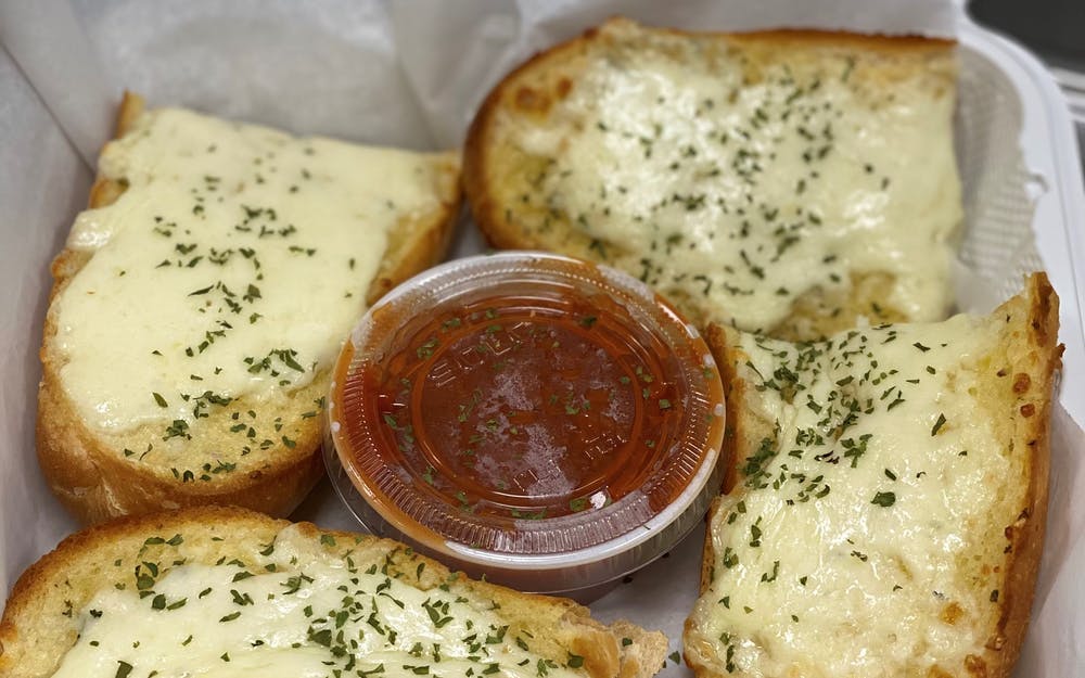 Order Garlic Bread with Cheese - Appetizer food online from Three Brothers Italian Restaurant store, Bladensburg on bringmethat.com