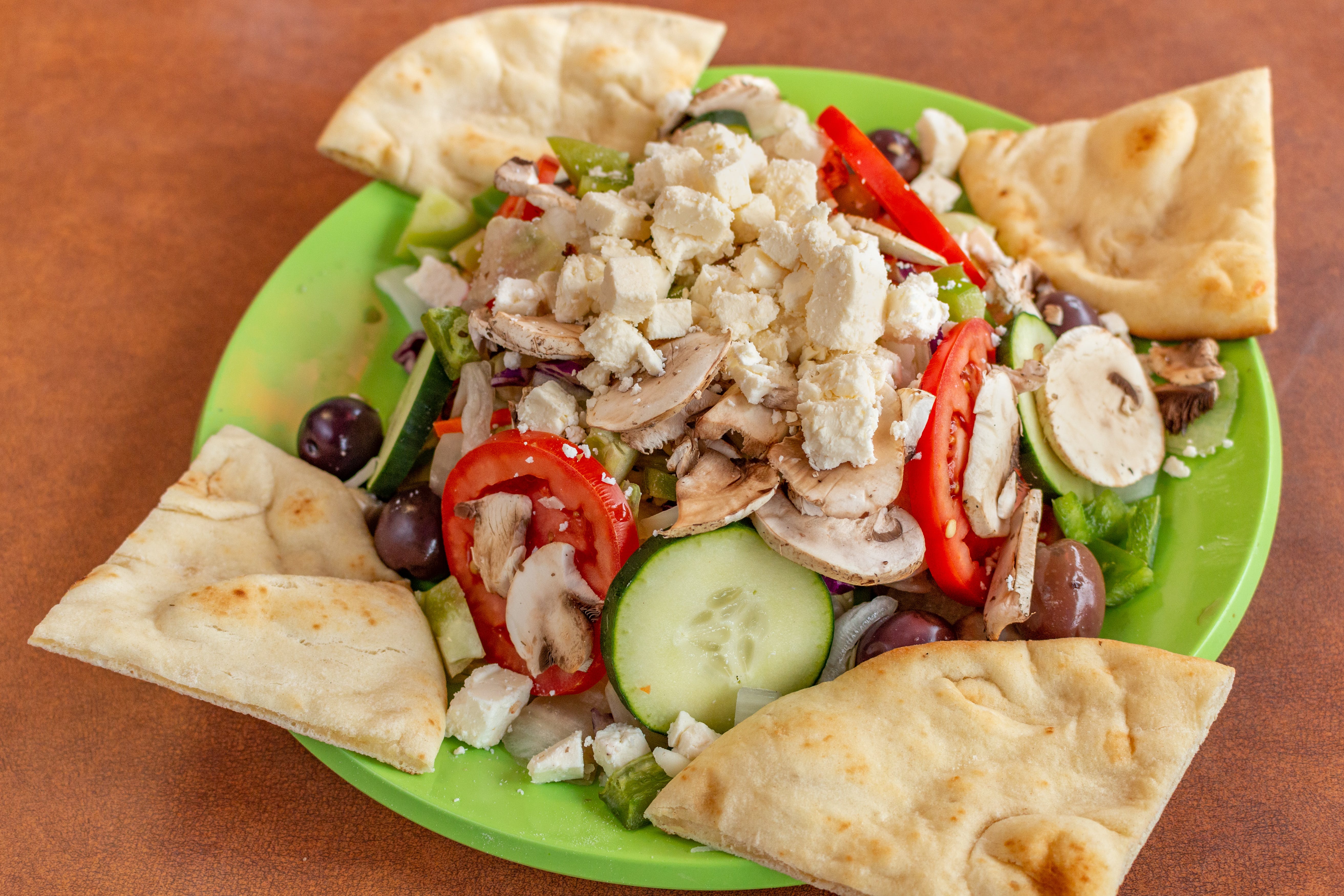 Order Famous Greek Salad - Salad food online from Famous Pizza store, Denver on bringmethat.com