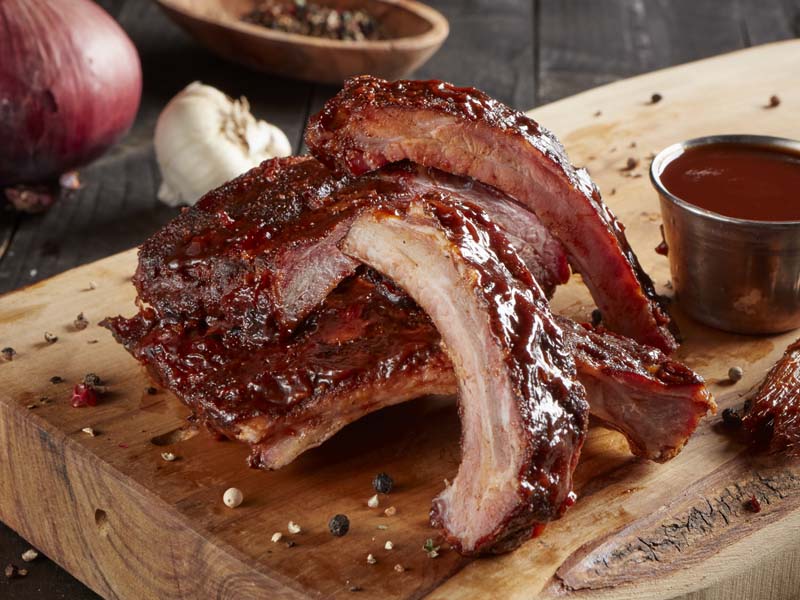 Order Barbequed Spare Ribs with Tangy Western BBQ Sauce food online from Brookwood Farms Carolina Pit BBQ store, Charlotte on bringmethat.com