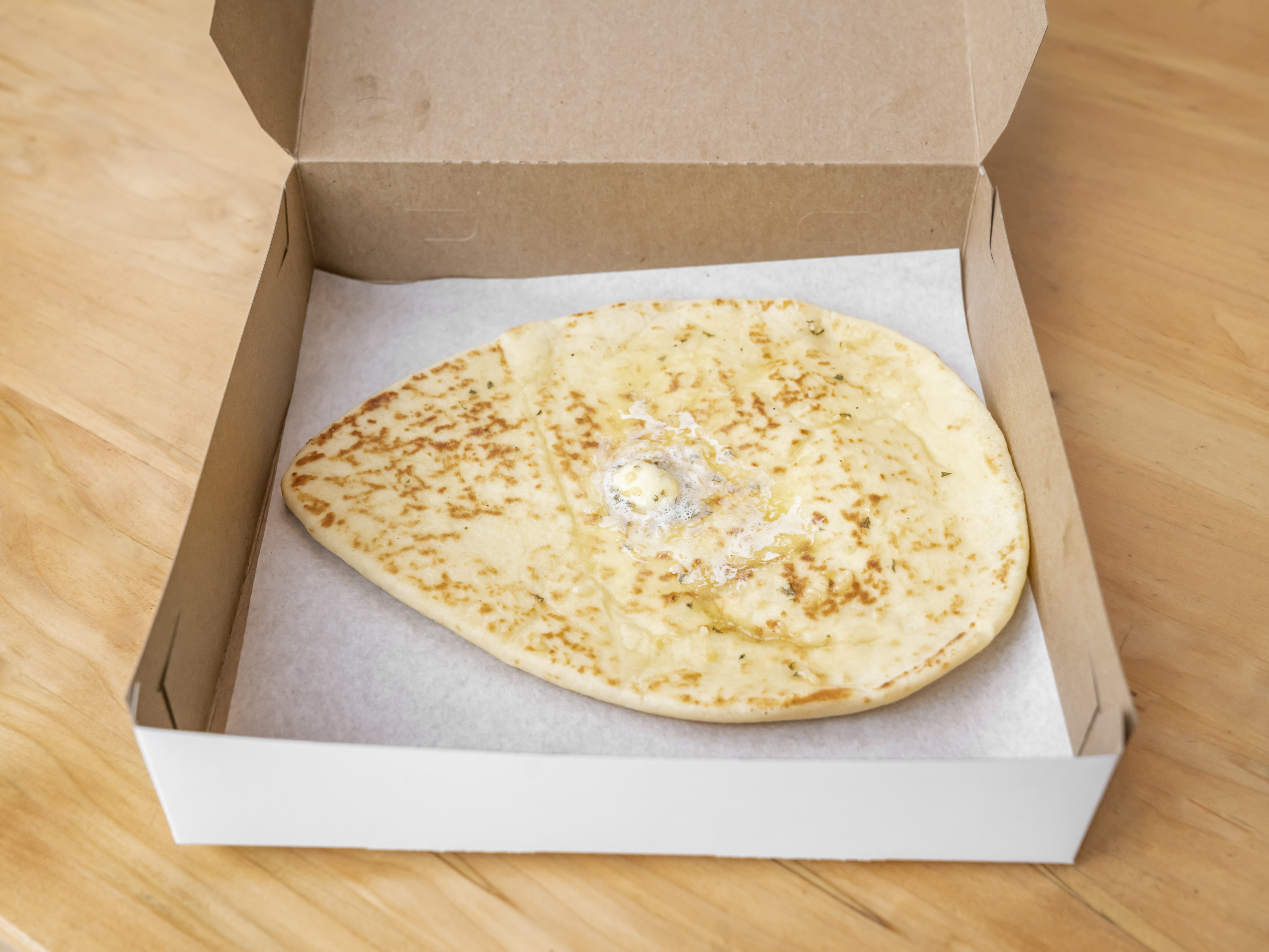 Order Garlic Naan food online from Bombay Burrito store, Willoughby on bringmethat.com