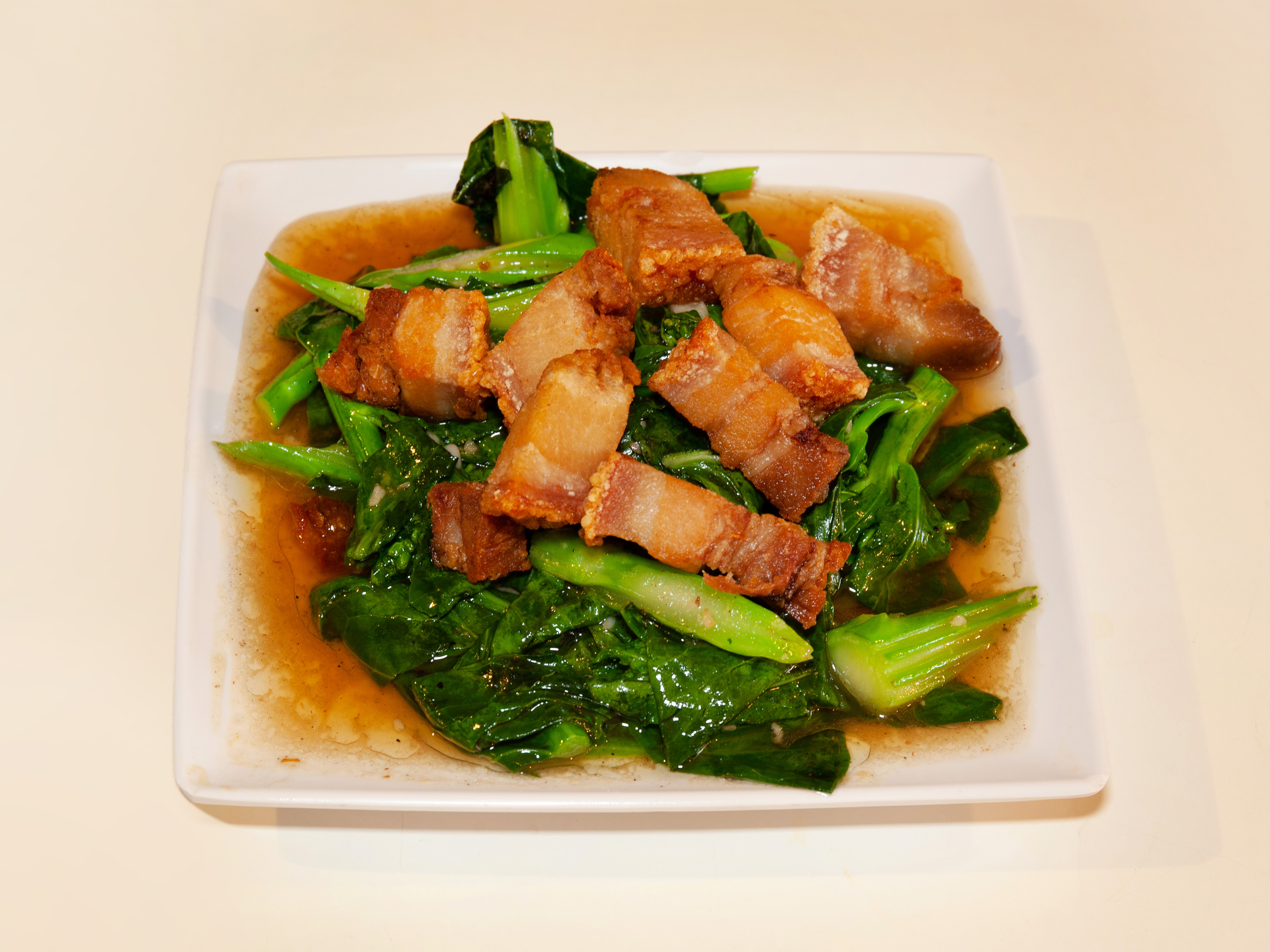 Order 27. Chinese Broccoli with Crispy Pork food online from Khun Dang Thai Restaurant store, North Hollywood on bringmethat.com