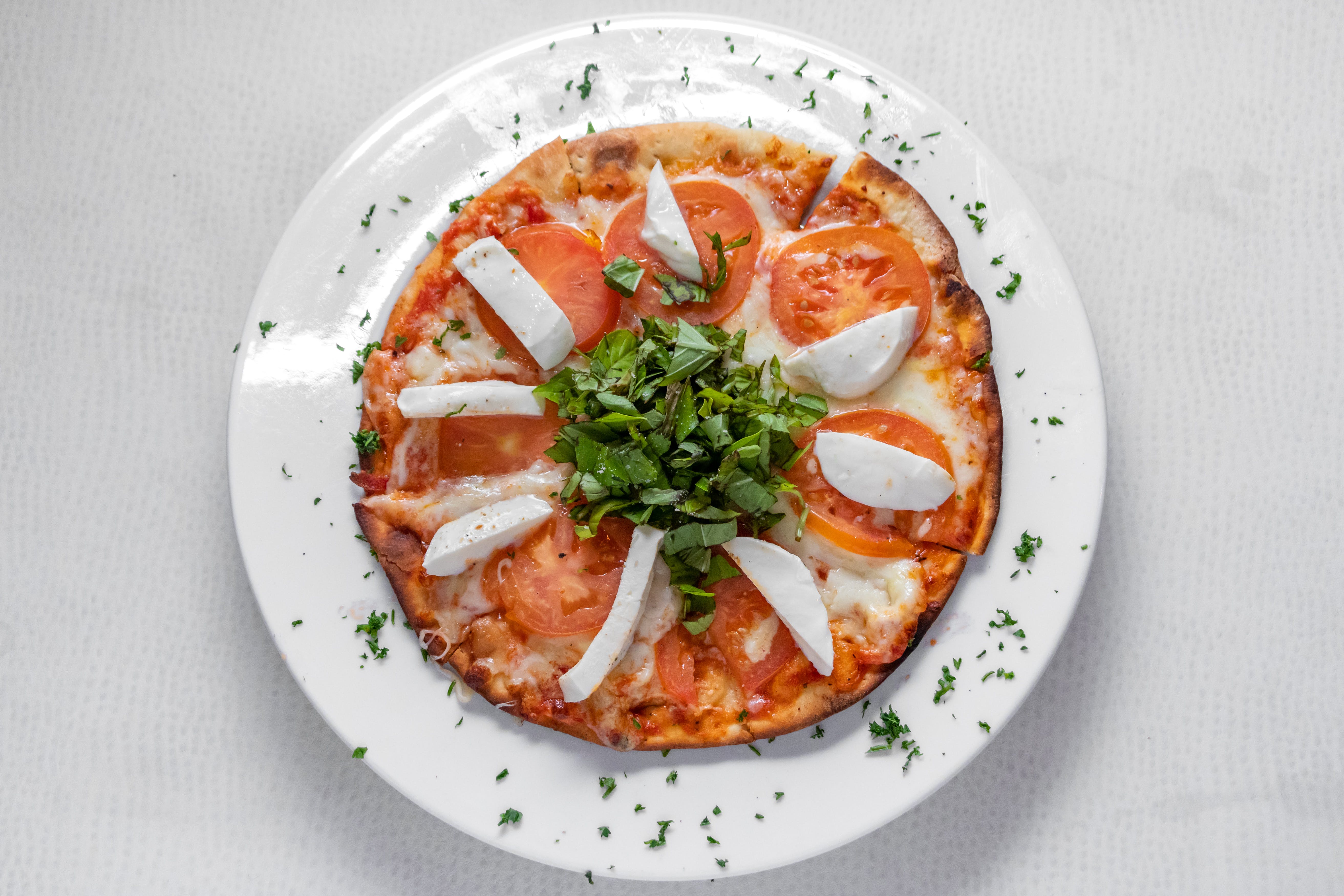 Order Margharita Pizza - 10'' (8 Slices) food online from Prima Pasta Restaurant store, Houston on bringmethat.com