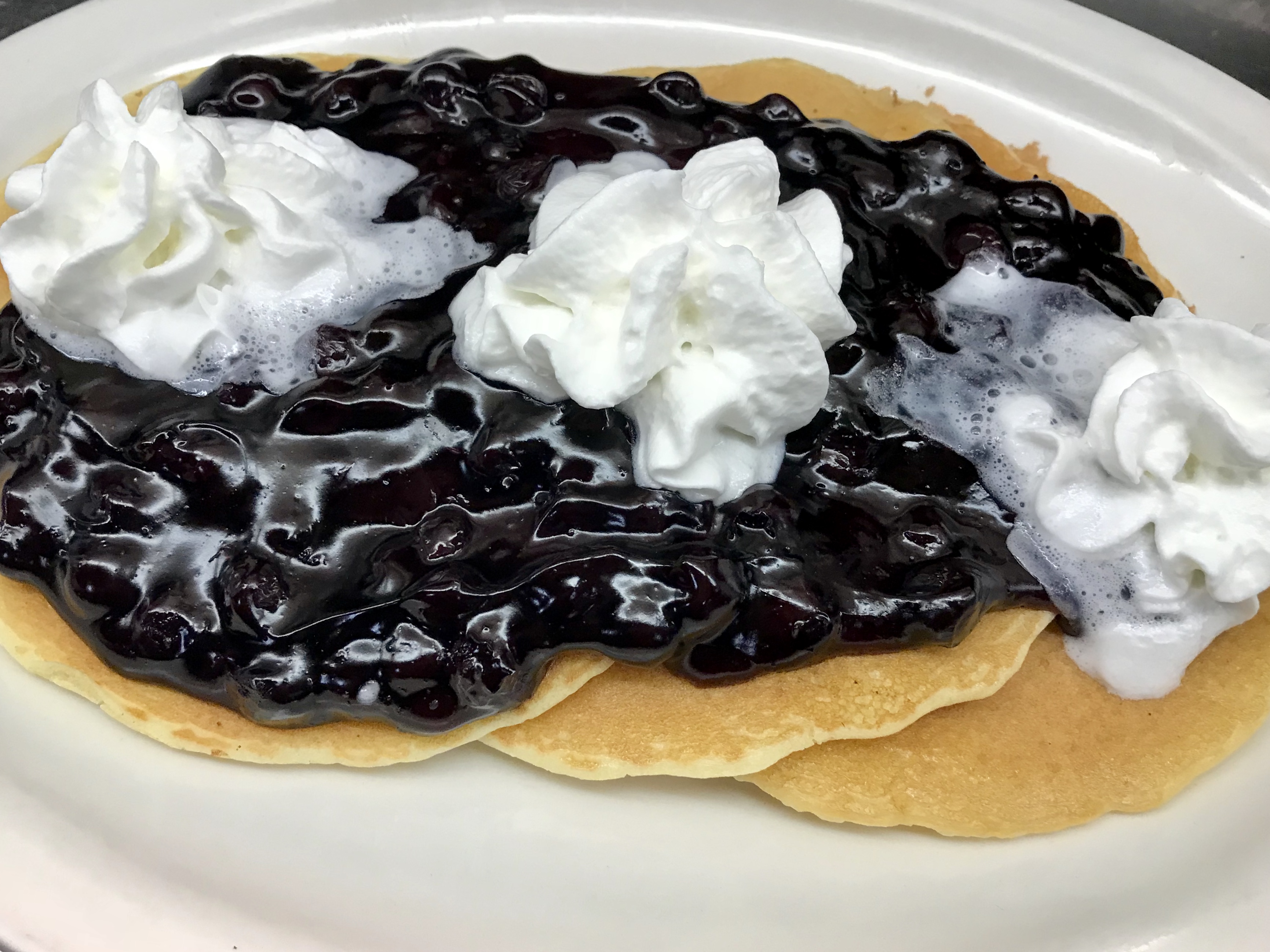 Order Blueberry Topped Pancakes  food online from Eastridge Family Restaurant store, Rochester on bringmethat.com