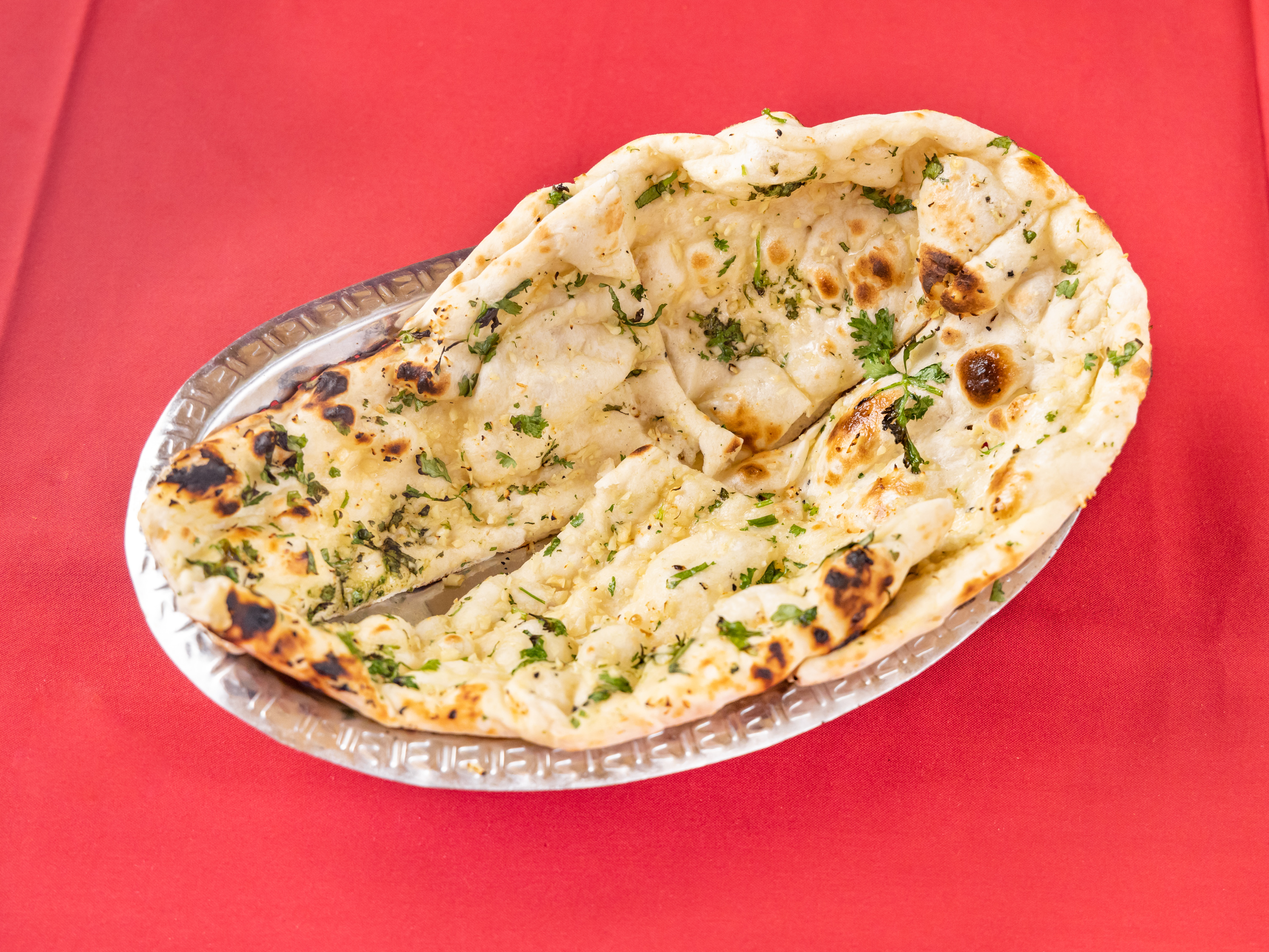 Order Garlic Naan food online from Lal Mirch Indian Restaurant store, Agoura Hills on bringmethat.com