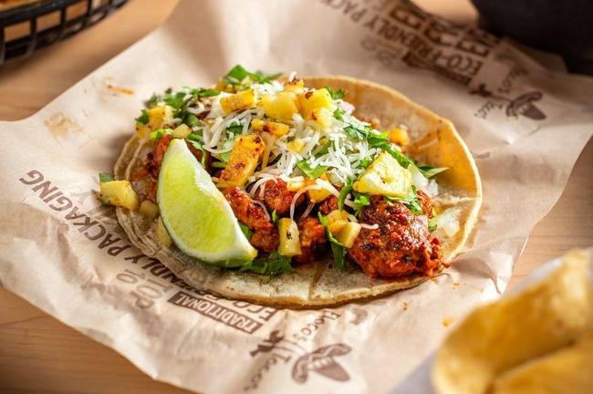 Order Al Pastor Taco food online from Flacos Tacos store, Chicago on bringmethat.com