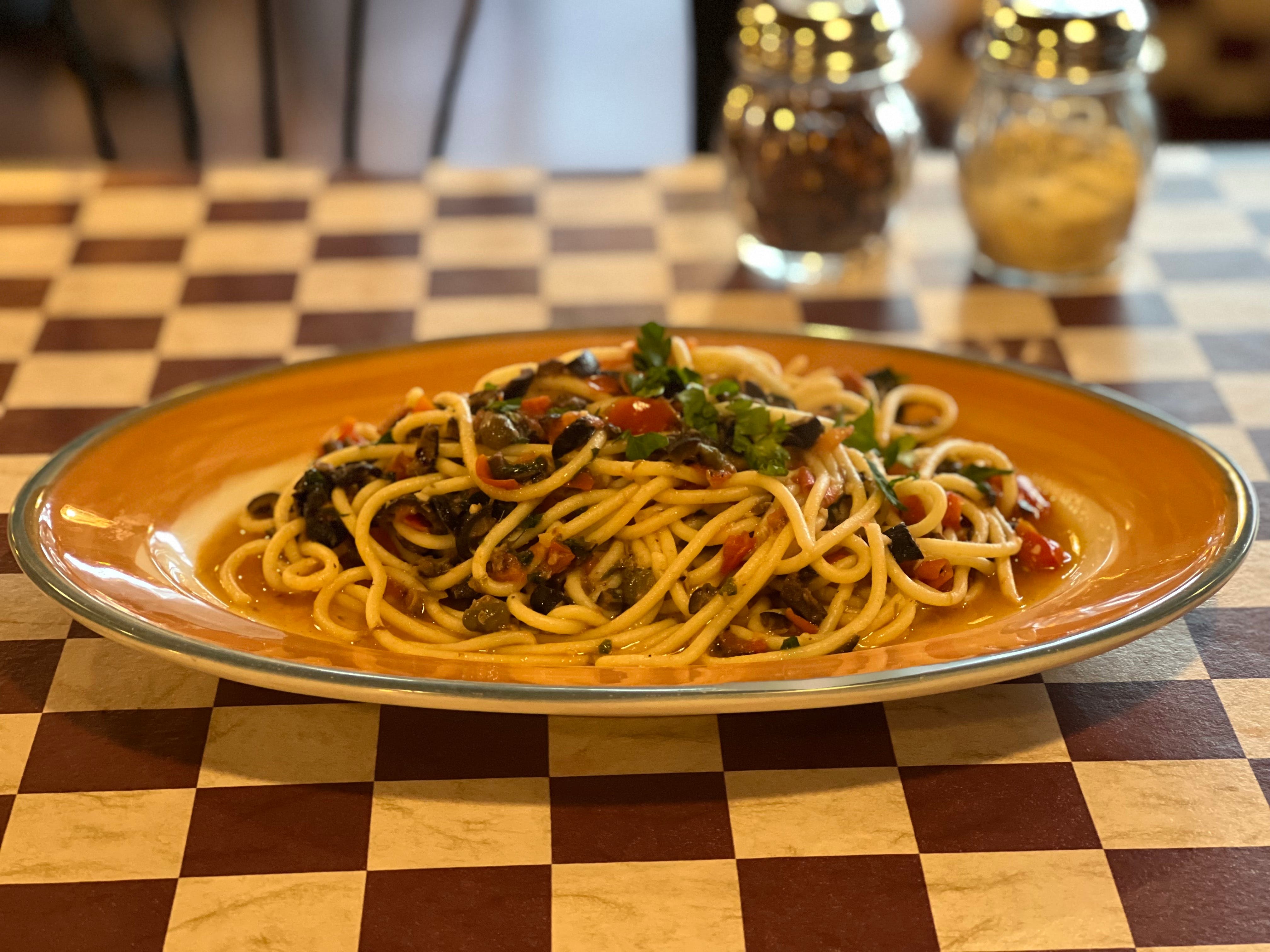 Order Spaghetti Puttanesca - Pasta food online from Village Pizza Restaurant store, Orinda on bringmethat.com