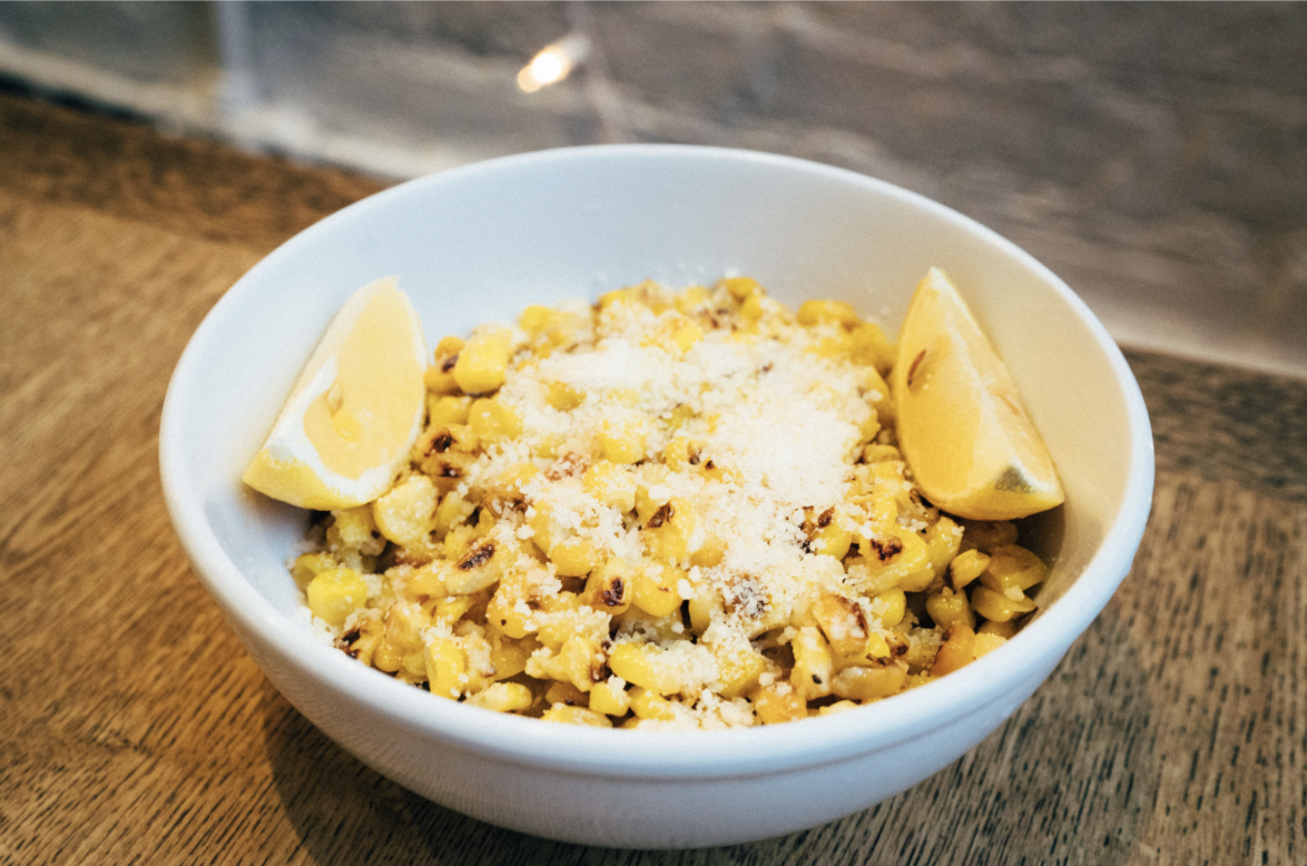 Order Sauteed Corn with parmesan 8oz food online from Poulette rotisserie chicken store, New York on bringmethat.com