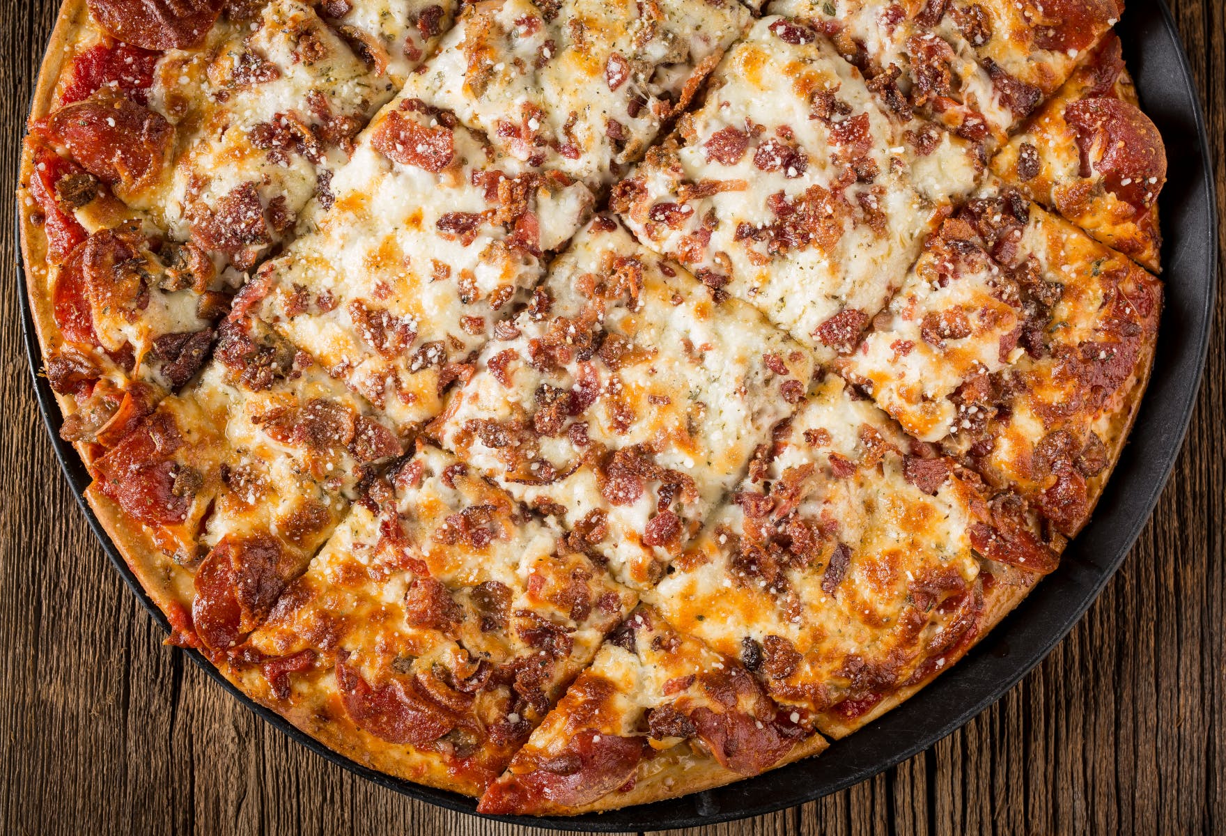 Order Meat Mania Pizza - 12'' (12 Slices, Serves 2 People) food online from Myrosati Pizza store, Freeport on bringmethat.com