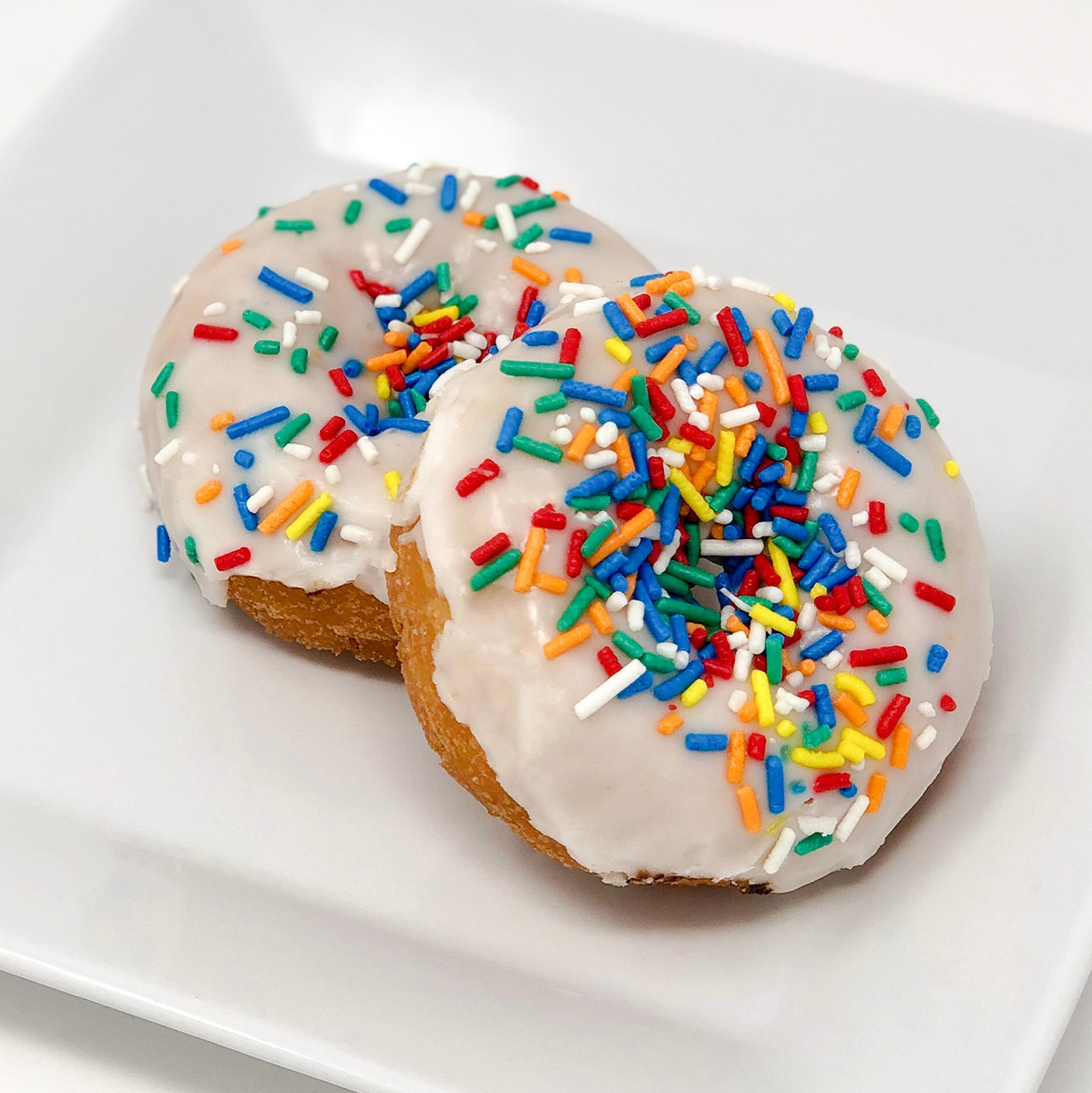 Order Vanilla Sprinkle Cake Donut food online from Merritt Bakery store, Tulsa on bringmethat.com