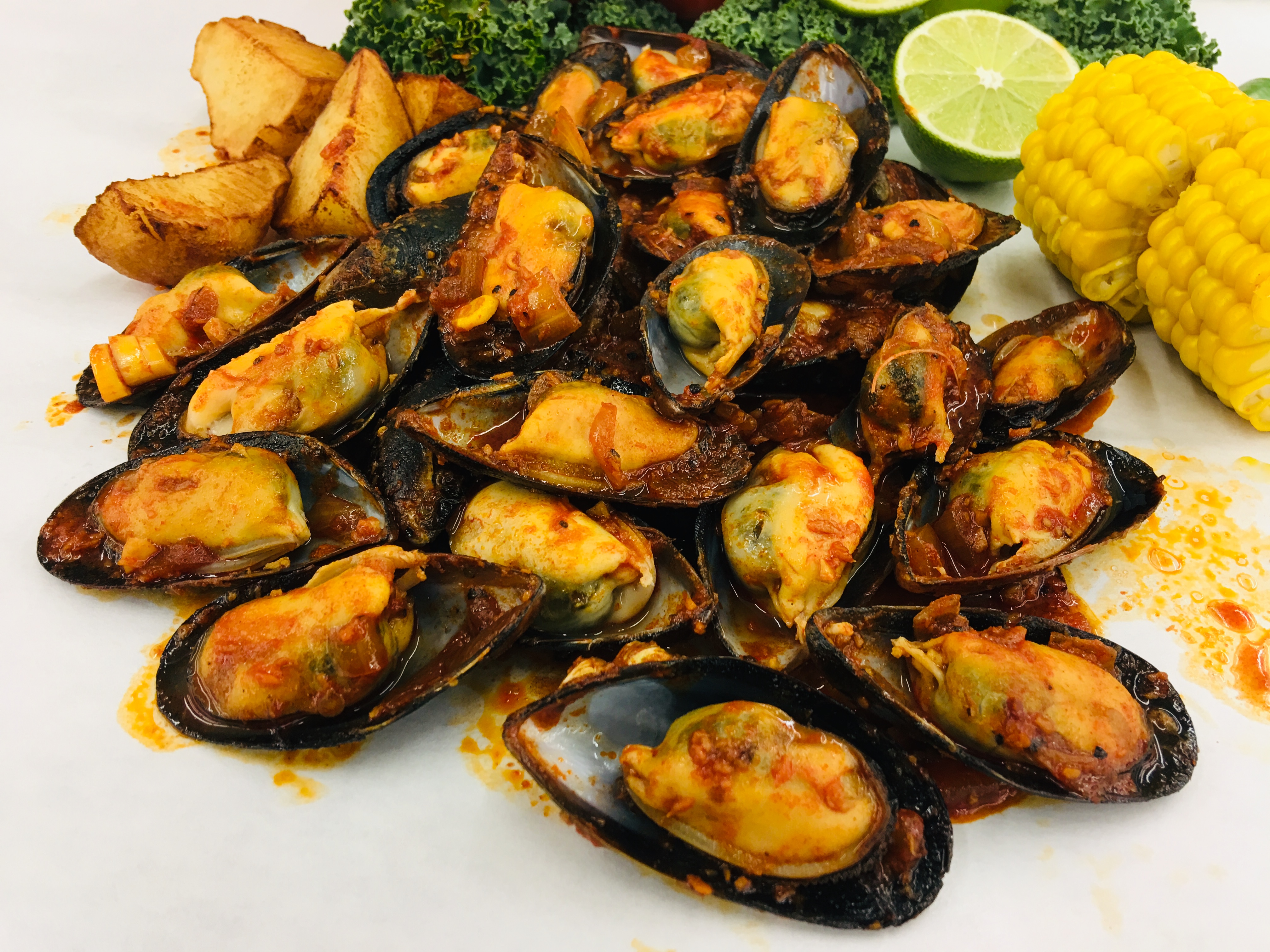 Order 1 / lb. 1/2 Shell Mussels food online from Cajun Shrimps store, El Monte on bringmethat.com