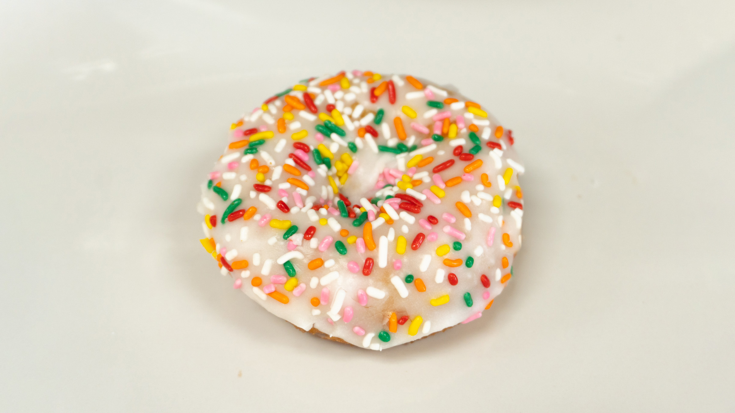 Order Vanilla Frosting Cake Donut food online from Rainbow Donuts store, Norwalk on bringmethat.com
