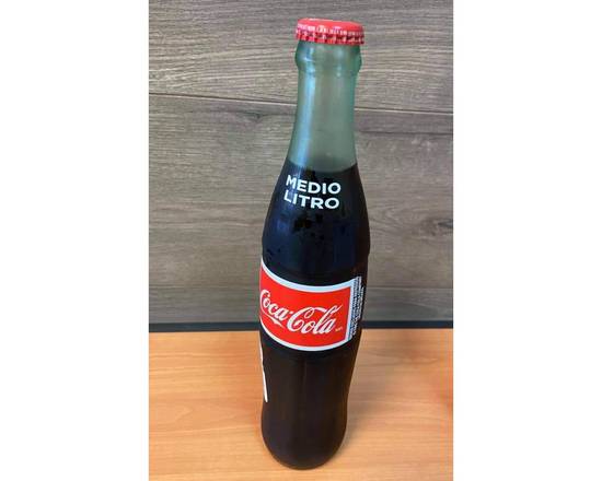 Order Half a Liter Coca Cola food online from 8th Street Deli store, National City on bringmethat.com