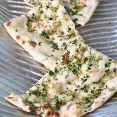 Order GARLIC CILANTRO NAAN (24) food online from Kabob & Curry store, Providence on bringmethat.com