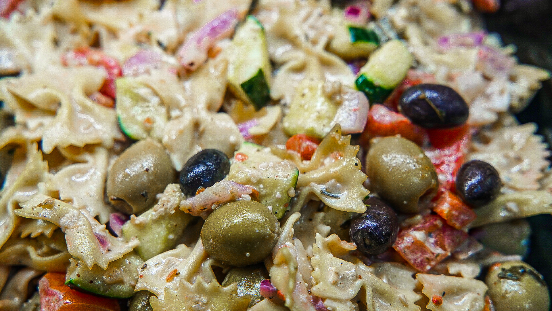 Order Greek Bowtie Pasta with Black Olives Tomato & Cucumber tossed in Red Wine Vinaigrette food online from Harry's Hilltop Catering Delicatessen store, Williston Park on bringmethat.com