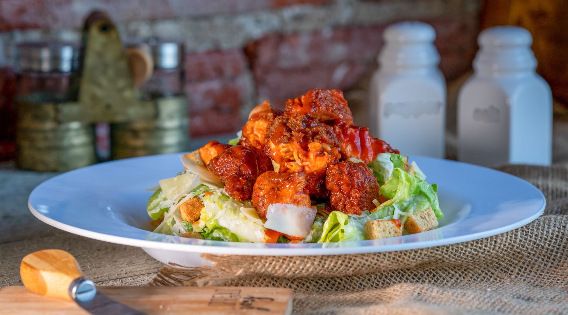 Order Crispy Chicken Caesar Salad  food online from The Butcher Grille store, Dearborn on bringmethat.com